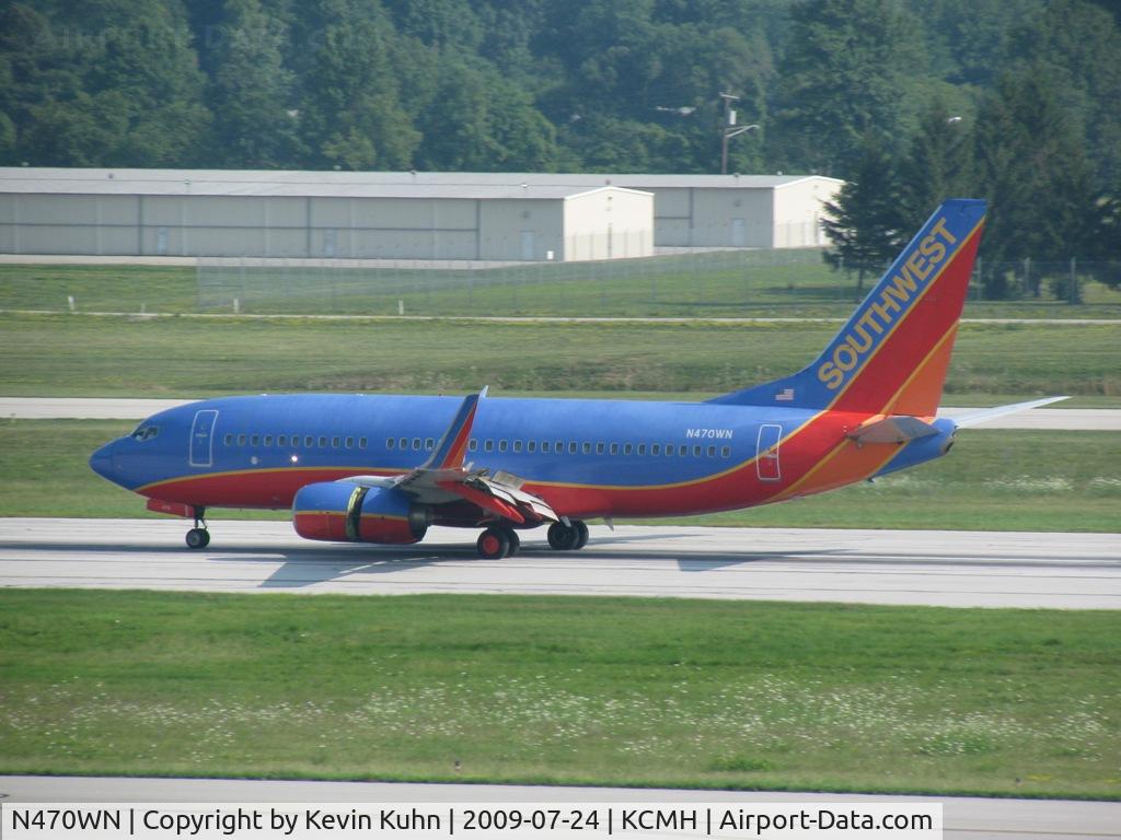 N470WN, 2004 Boeing 737-7H4 C/N 33860, Rolling down 28R after landing. 10R/28L were closed this day, so I was able to catch all the traffic that morning on one side of the parking lot!