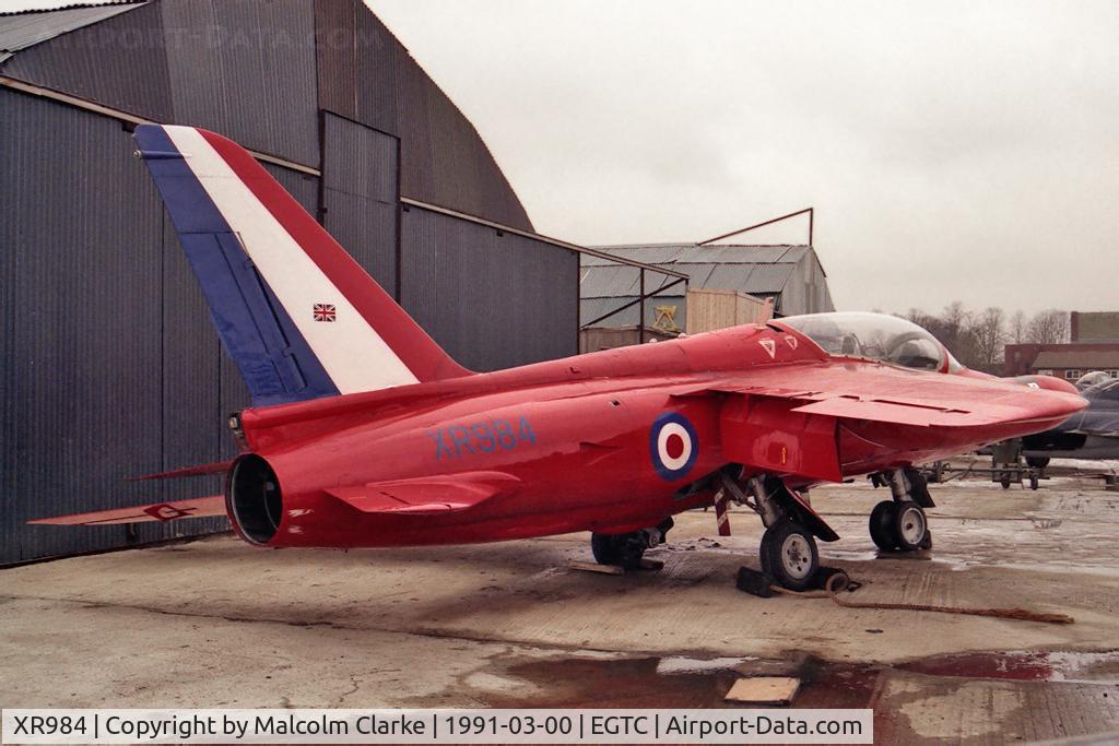 XR984, 1966 Hawker Siddeley Gnat T.1 C/N FL581, Hawker Siddeley Gnat T1. Previously with RAF 4 FTS and No 1 SoTT. Seen here in 1991 at the VAT facility at Cranfield prior to shipment to the USA. Now at the San Diego Flight Museum (N316RF).