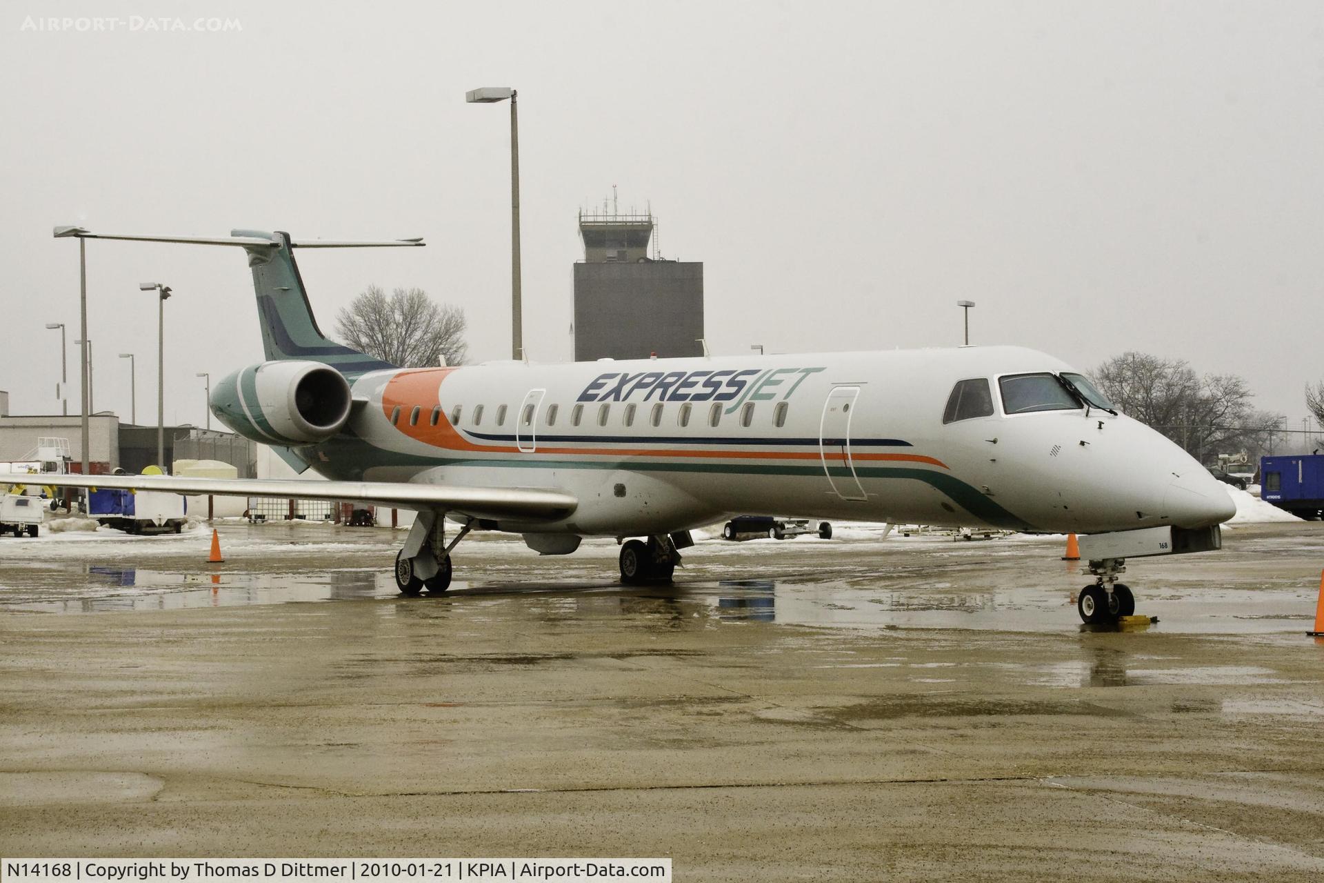 N14168, 2004 Embraer ERJ-145XR (EMB-145XR) C/N 14500840, Express Jet (N14168) right front with tower in background