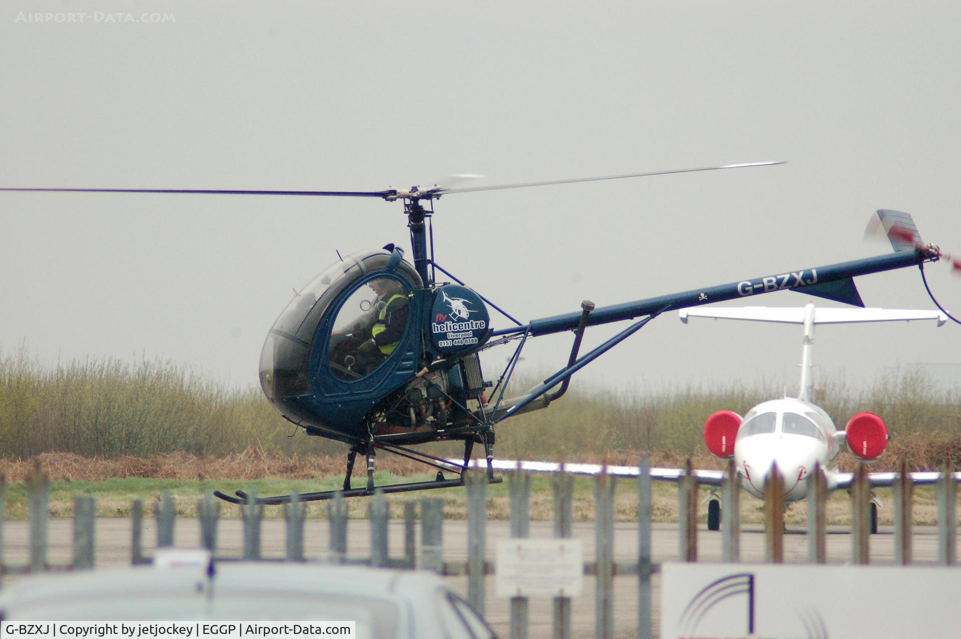 G-BZXJ, 2001 Schweizer 269C-1 C/N 0128, Taking off from LPL John Lennon