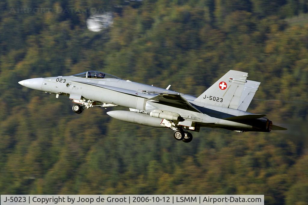 J-5023, McDonnell Douglas F/A-18C Hornet C/N 1372/SFC023, Take off in the warm autumn evening light for an air to ground mission. Note the targeting pod