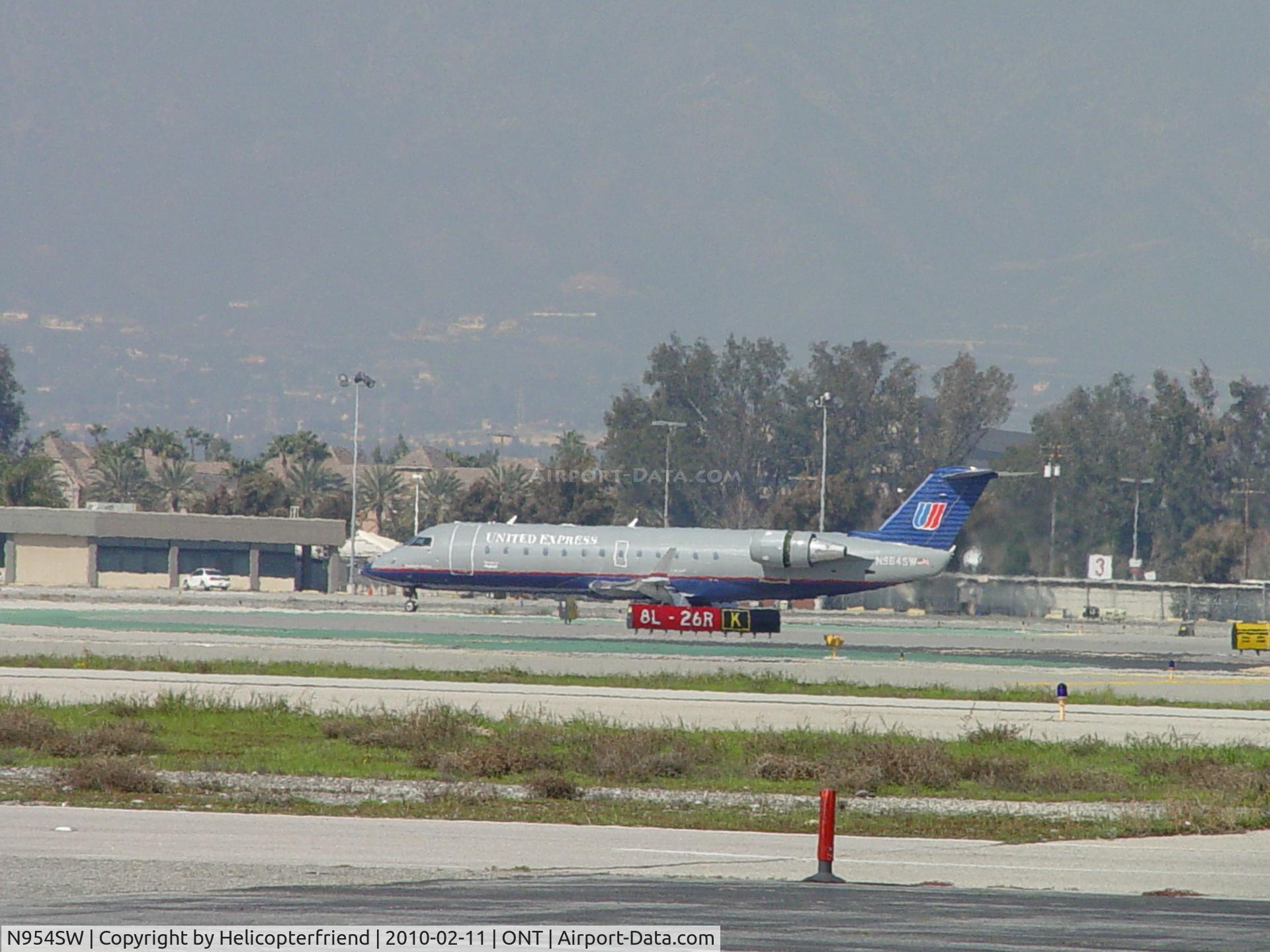 N954SW, 2003 Bombardier CRJ-200LR (CL-600-2B19) C/N 7815, Rolling out on runway 26R, taxiing back to terminal
