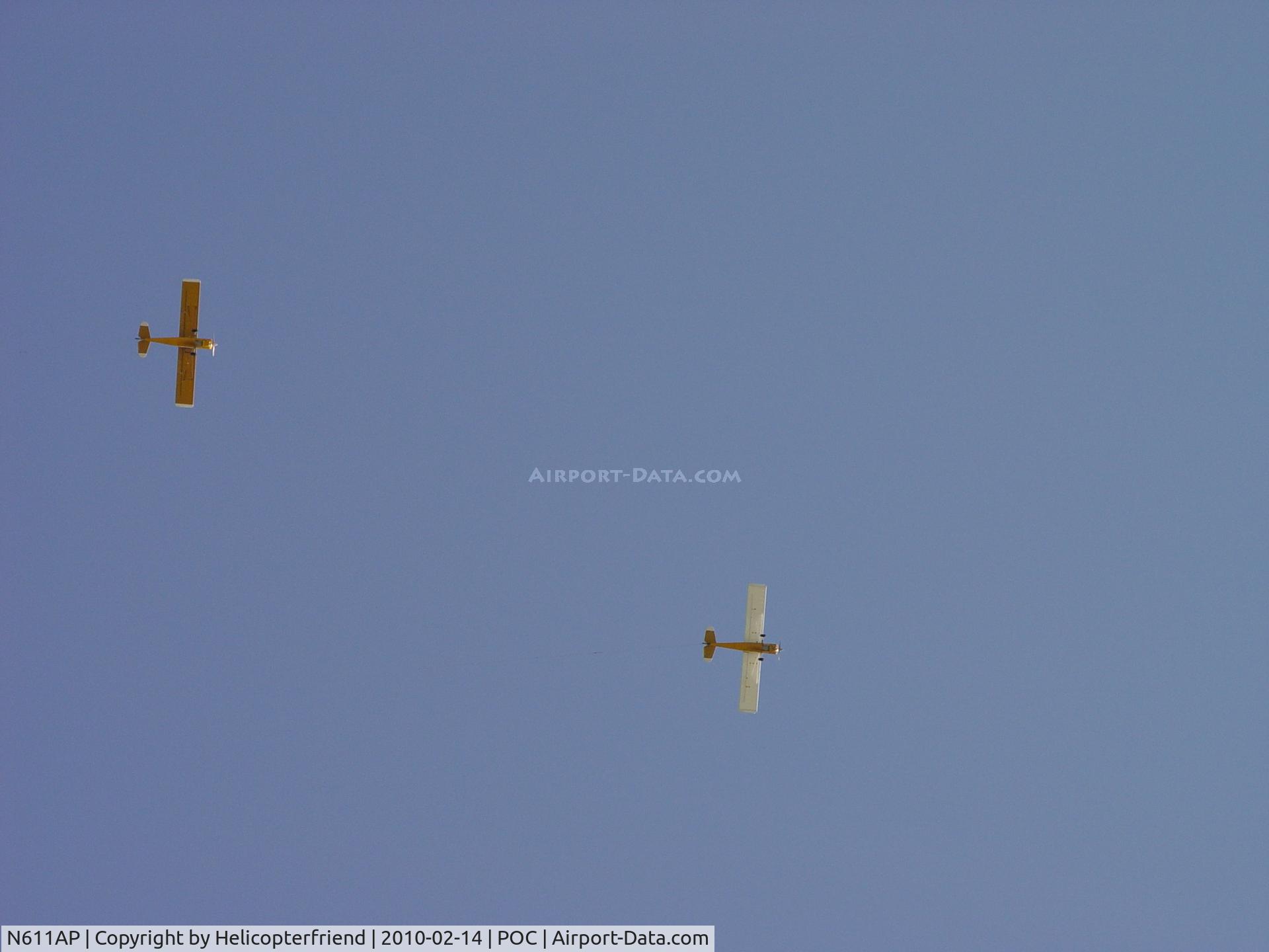 N611AP, 1979 Bellanca 8GCBC C/N 317-79, Flying wingman position in a flight of two banner planes at Pomona Winternationals