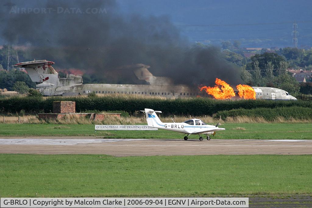 G-BRLO, 1978 Piper PA-38-112 Tomahawk Tomahawk C/N 38-78A0621, Piper PA-38-112 Tomahawk. Previously N2397K, a local Tomahawk turns for take-off as the airport fire brigade subjects a BEA Trident to yet another training exercise.