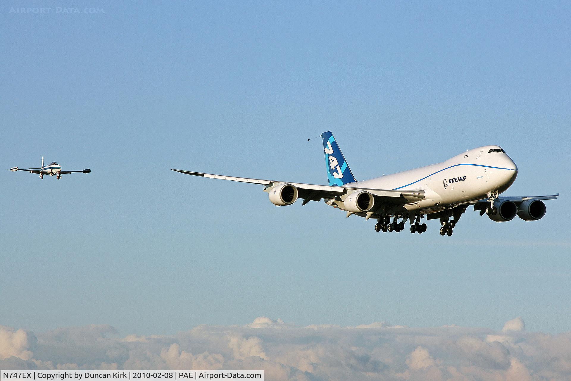 N747EX, 2010 Boeing 747-8F C/N 35808, First flight on finals with chase plane T-33
