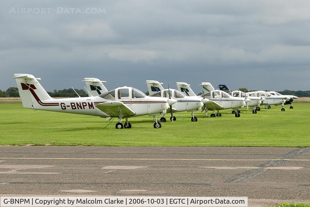 G-BNPM, 1979 Piper PA-38-112 Tomahawk Tomahawk C/N 38-79A0374, Piper PA-38-112 Tomahawk at Cranfield Airport in 2006. A quartet of Tomahawks with a brace of Arrows awaiting student pilots.