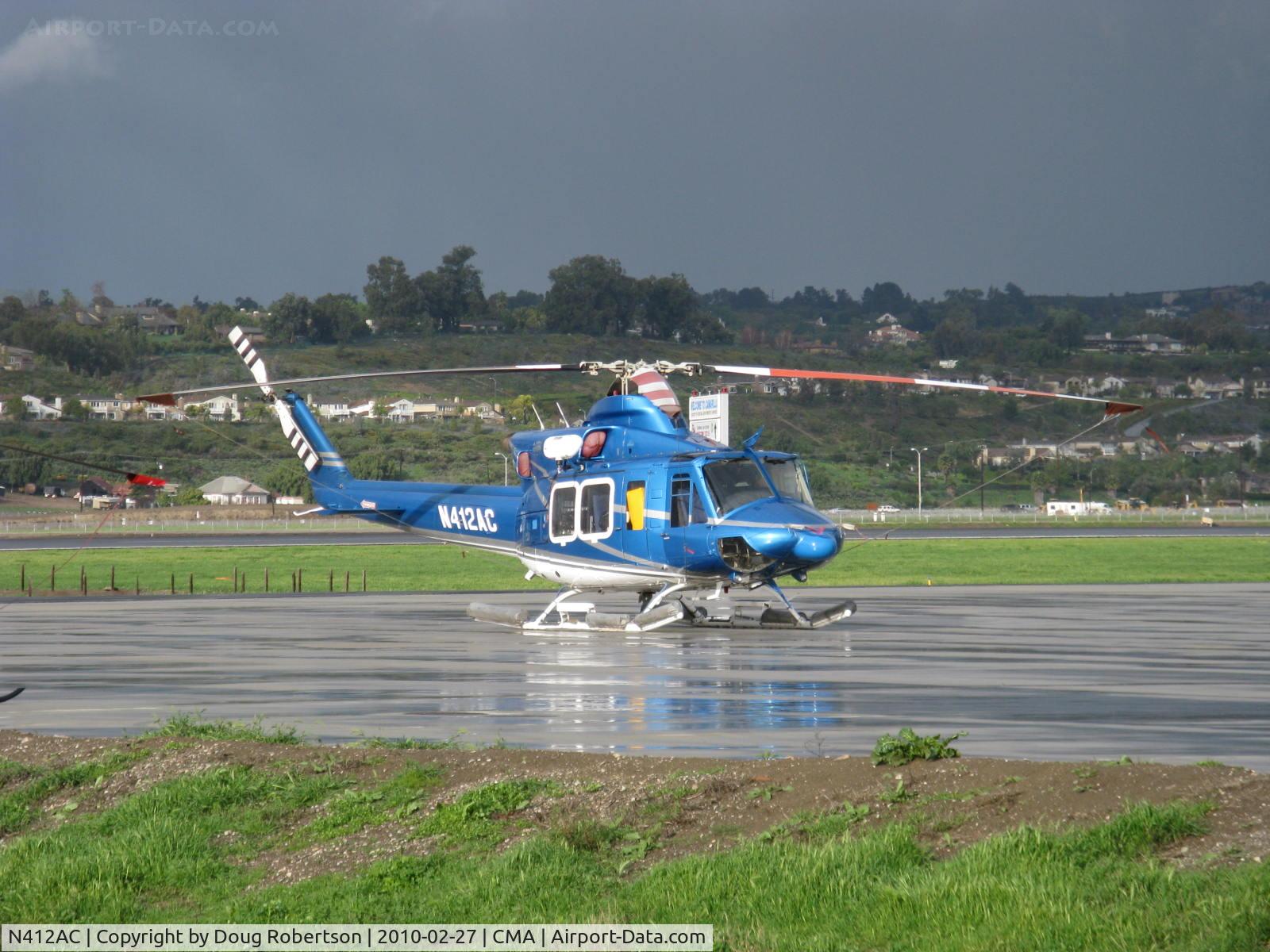 N412AC, 2003 Bell 412EP C/N 36320, 2003 Bell 412EP (Enhanced Performance), P&W(C)PT6T-3D TWIN PAC 1,800 shp for takeoff, 1,600 shp max continuous, on SUN AIR JETS ramp, in a shaft of sunlight between rain showers