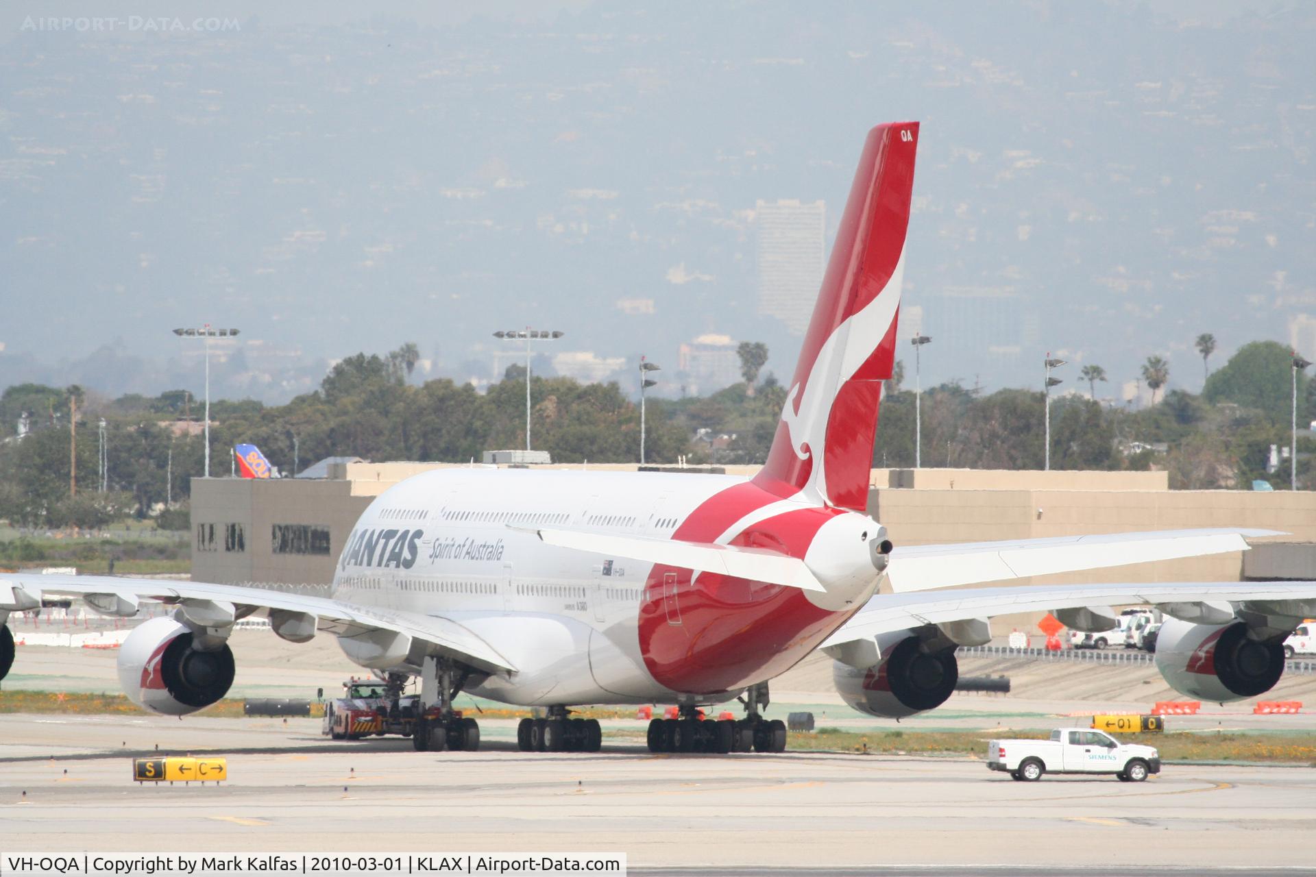 VH-OQA, 2008 Airbus A380-842 C/N 014, Qantas Airbus A380-842, VH-OQA, getting a tug to maintenance via taxiway Quebec after arriving from YSSY as QFA11.