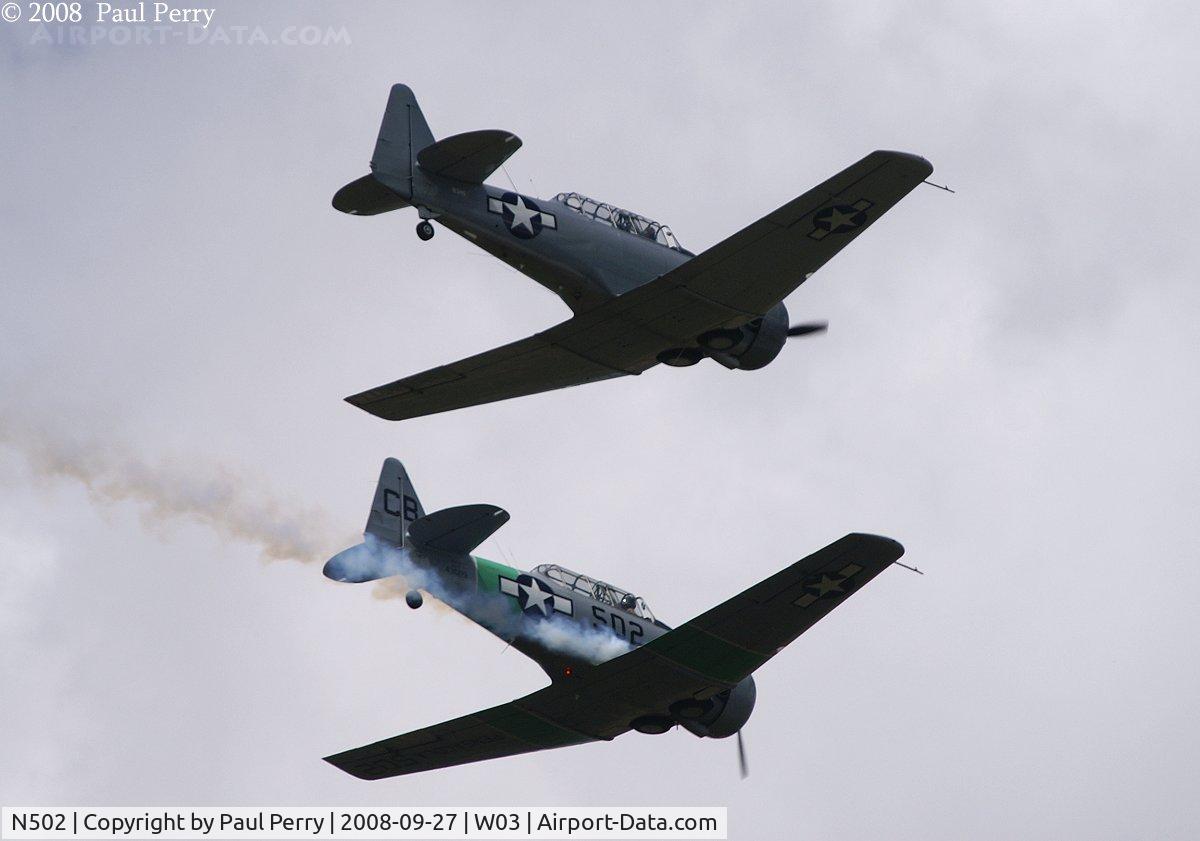 N502, 1941 North American SNJ-5 Texan Texan C/N 43689, Smoke on, with N3HG on the wing