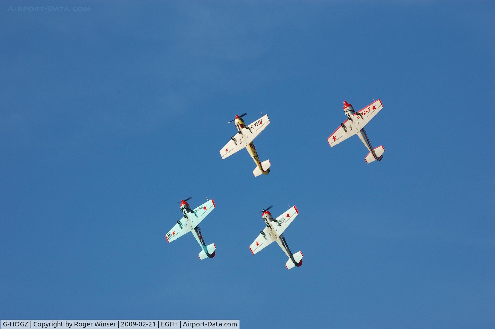 G-HOGZ, 1990 Bacau Yak-52 C/N 9010313, As Osprey 2 in formation practice over the airport. De-registered 20/06/2011 and transferred to Russia.