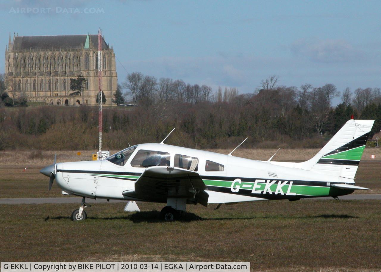 G-EKKL, 1984 Piper PA-28-161 Warrior II C/N 28-8416087, RESIDENT WARRIOR II WITH LANCING COLLEGE CHAPEL BEHIND. SHOREHAM