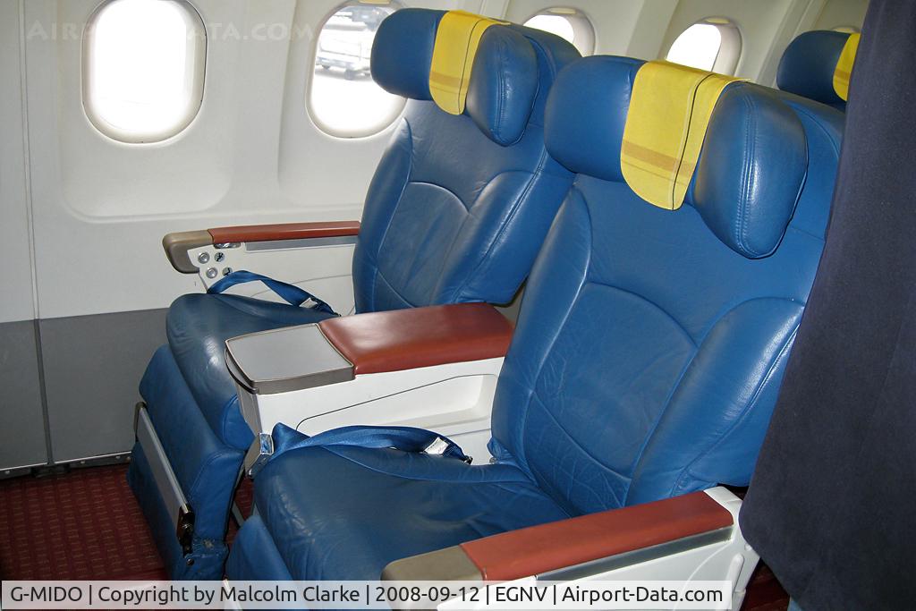 G-MIDO, 2002 Airbus A320-232 C/N 1987, Airbus A320-232 at Durham Tees Valley Airport in 2008. Front starboard seats.