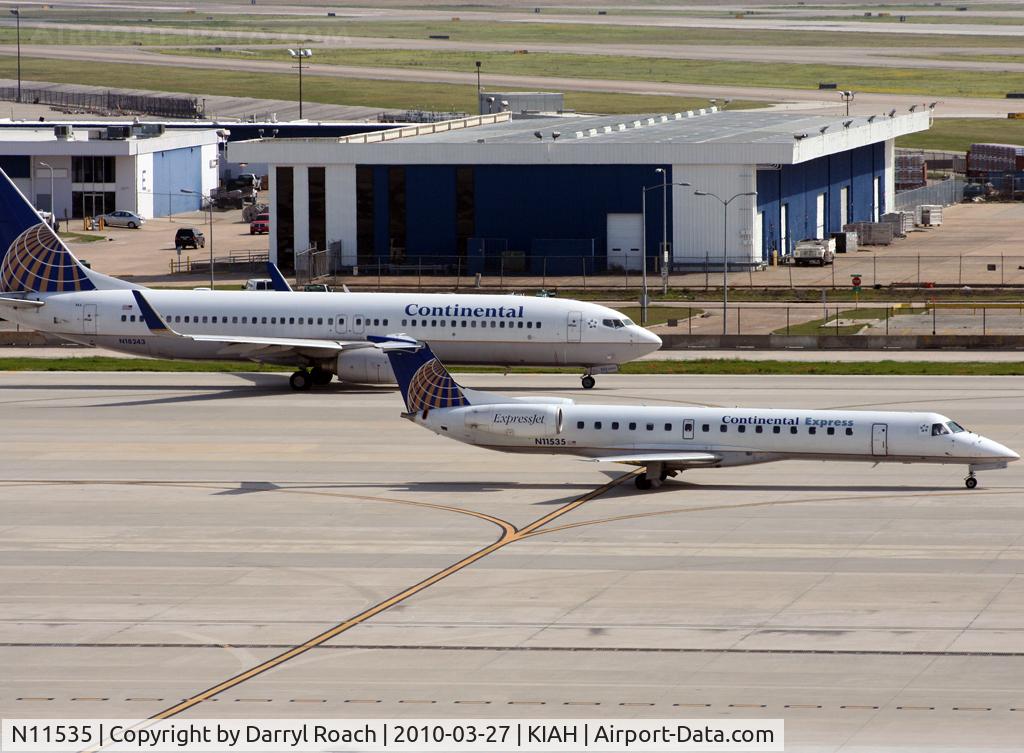N11535, 2001 Embraer ERJ-145LR (EMB-145LR) C/N 145518, Utilizing both taxiways, an ERJ is followed by a company 73.