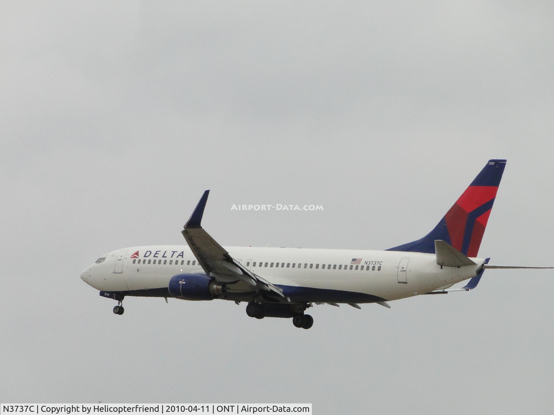 N3737C, 2000 Boeing 737-832 C/N 30799, Over the outer fence to runway 26R