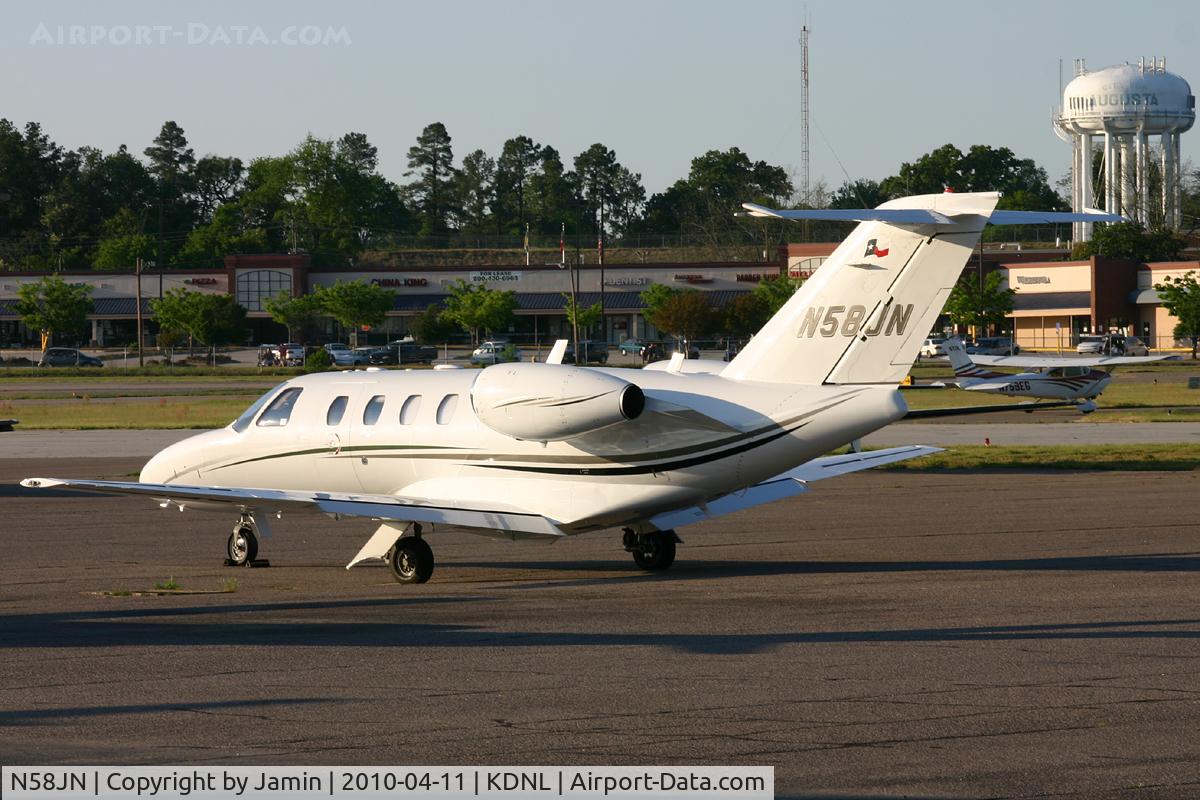 N58JN, 2006 Cessna 525 CitationJet CJ1+ C/N 525-0607, Parked on the ramp during the golf tournament, with a departing Skylane and a few spotters in the background.