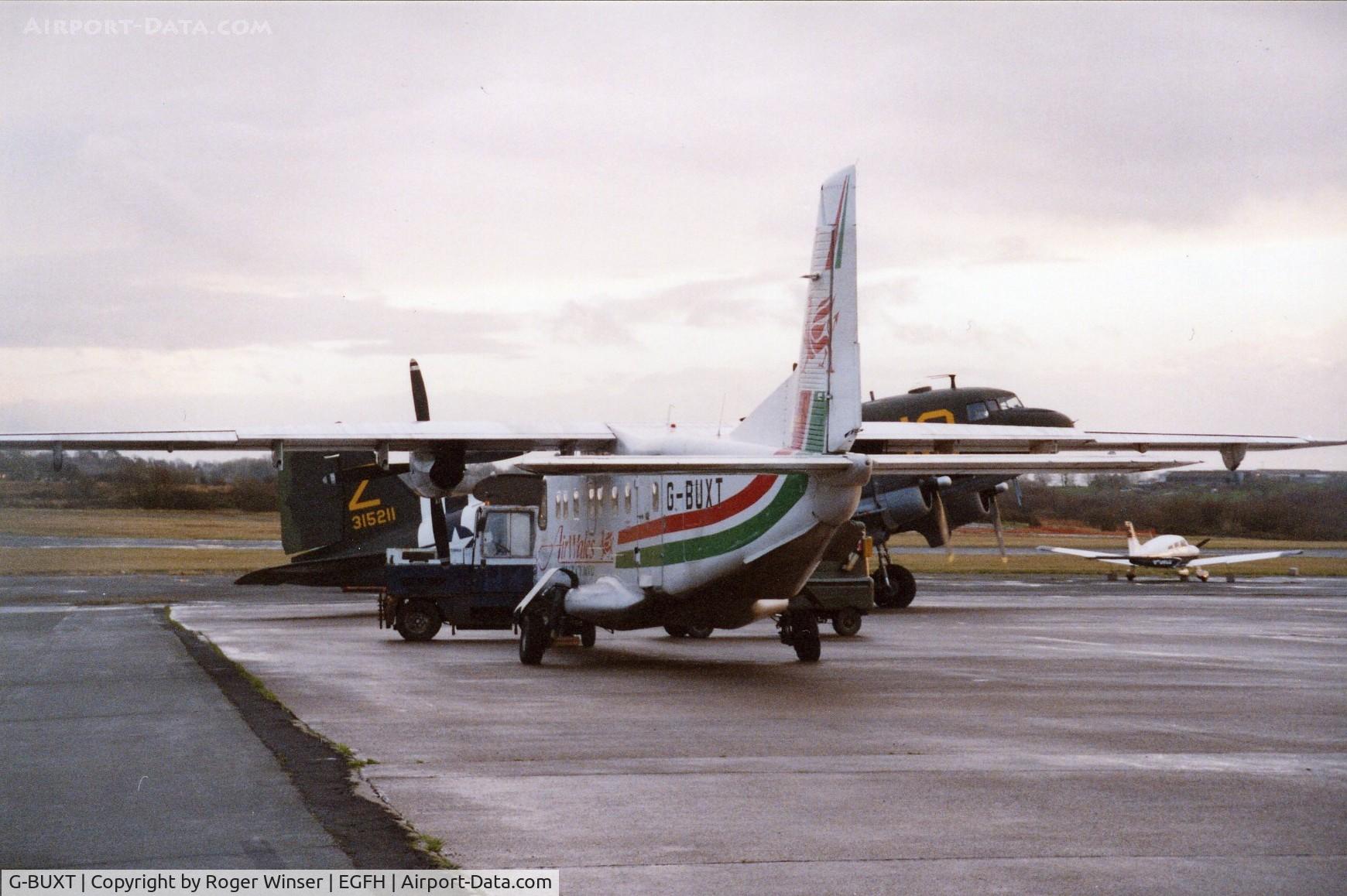 G-BUXT, 1986 Dornier 228-202K C/N 8065, Seen in 2002? with C-47A N1944A/315211 coded Z/J8 in the background