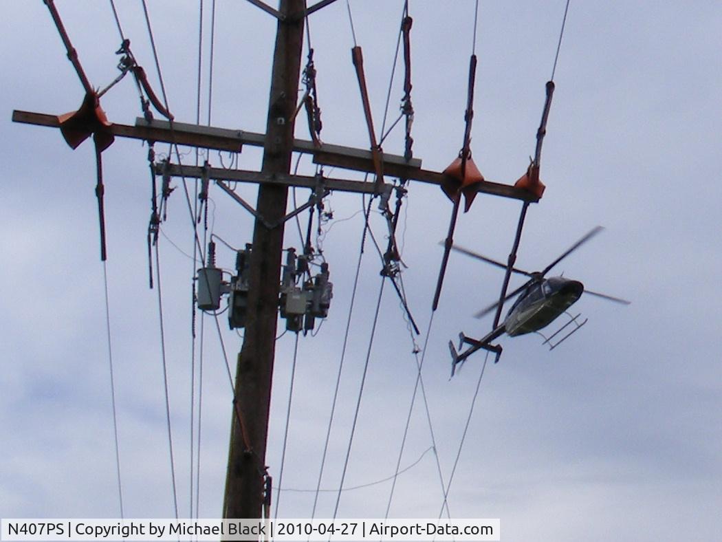 N407PS, 2001 Bell 407 C/N 53467, low and slo over some line repairs in Carlisle Ohio