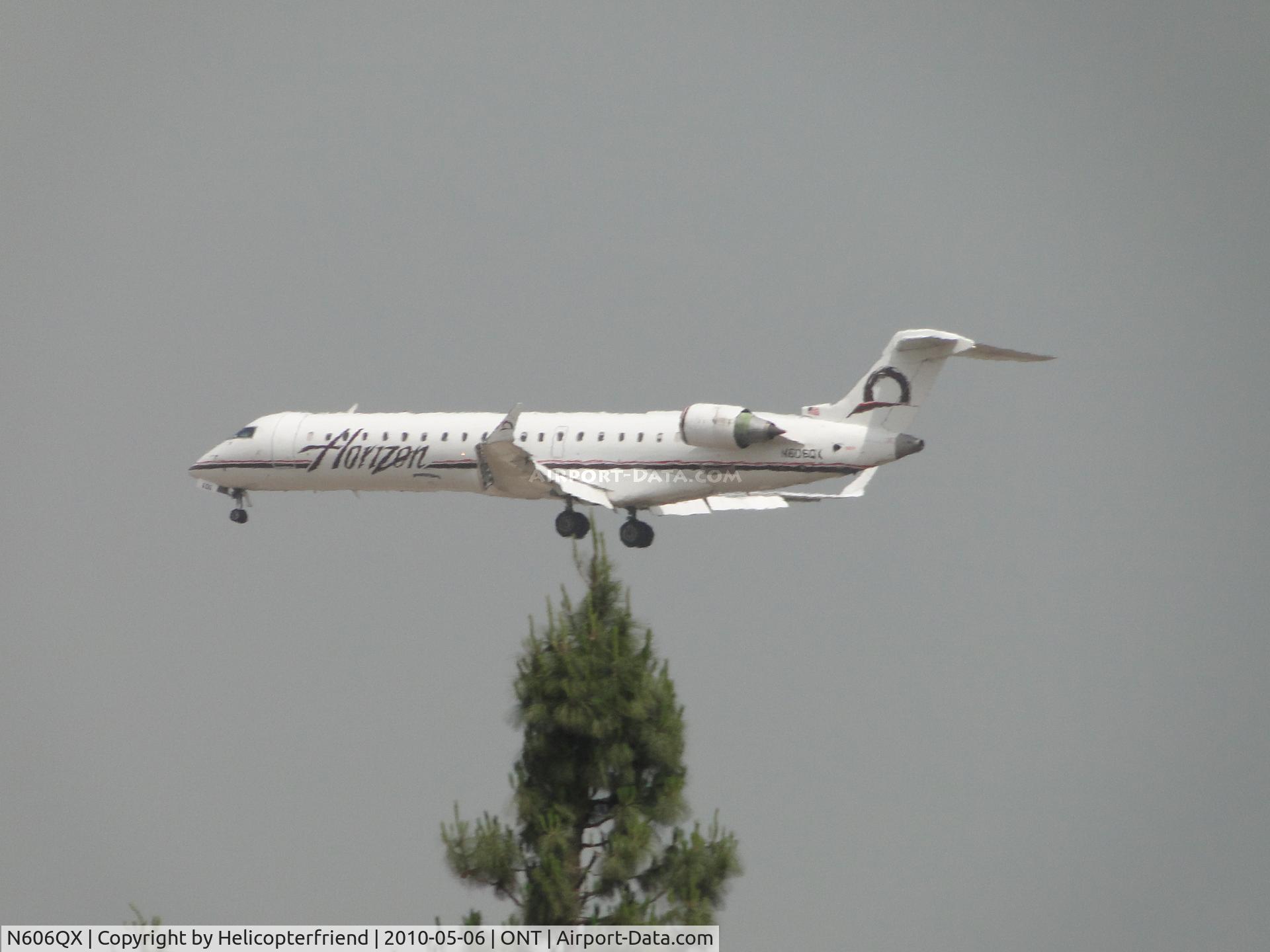 N606QX, 2001 Bombardier CRJ-701 (CL-600-2C10) Regional Jet C/N 10023, Over the threshold for runway 26R