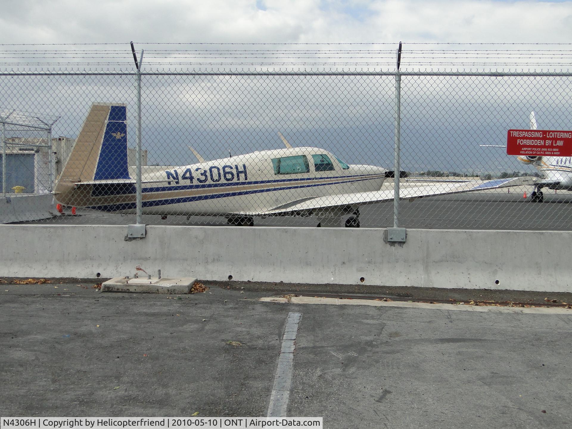 N4306H, 1978 Mooney M20J 201 C/N 24-0702, Parked just inside the fenced perimeter