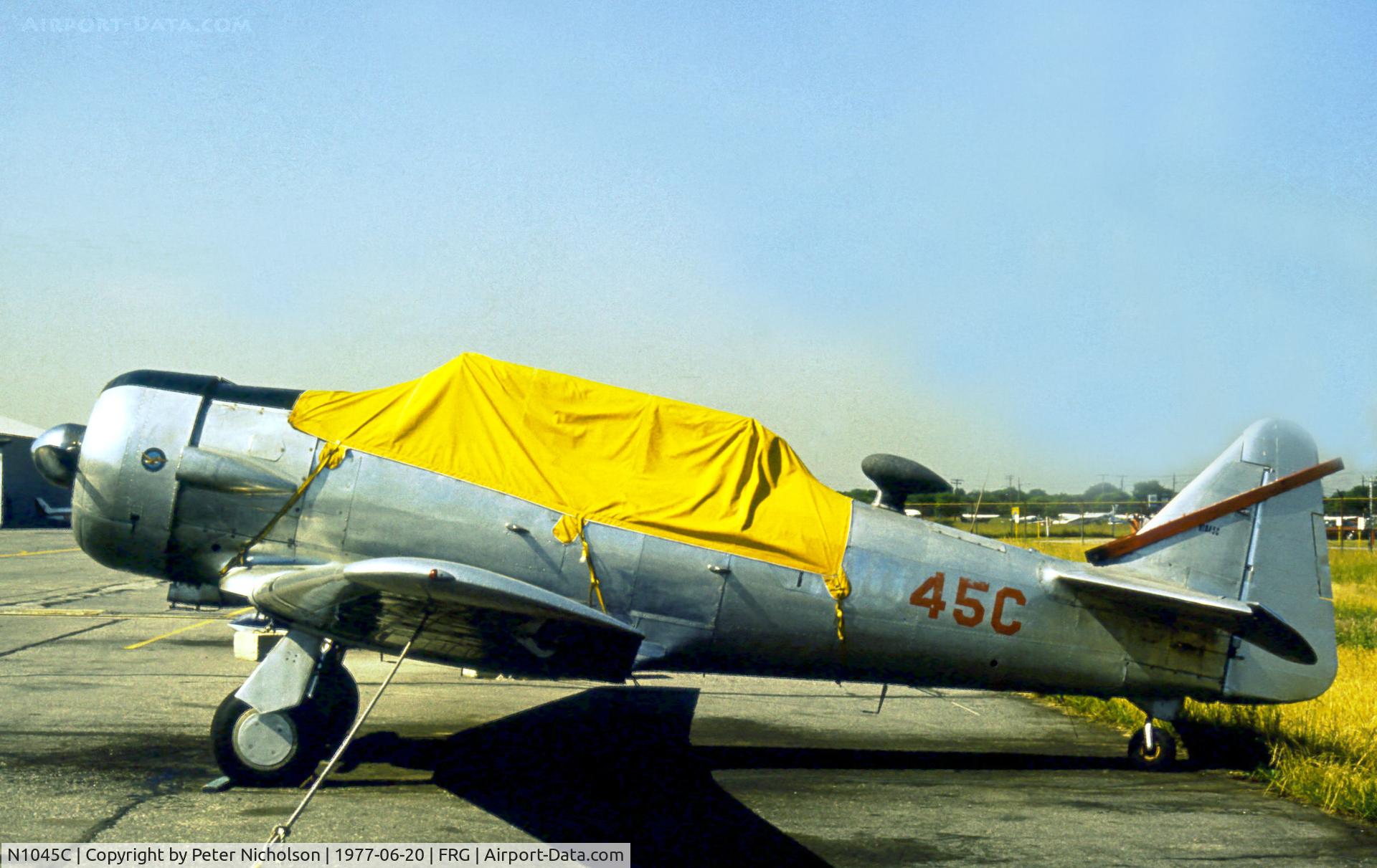 N1045C, 1941 North American SNJ-5 Texan Texan C/N 88-15665, SNJ-5 ex Bu.43724 parked at Republic Airport on Long Island in the Summer of 1977.
