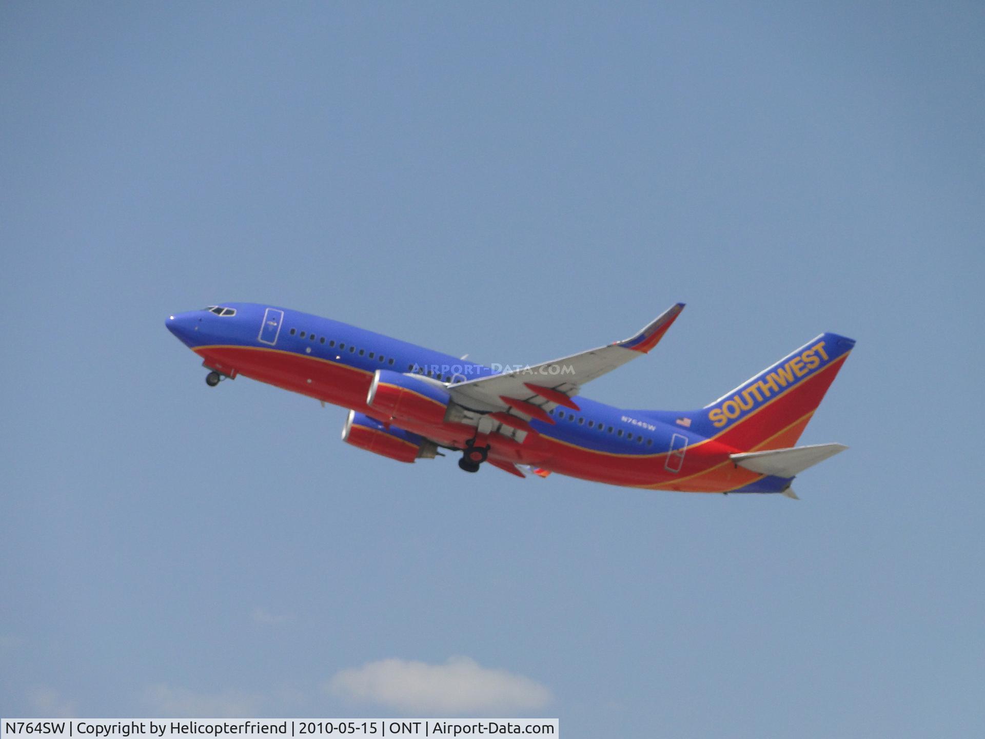 N764SW, 2000 Boeing 737-7H4 C/N 27878, Wheels coming up after taking off from runway 26R