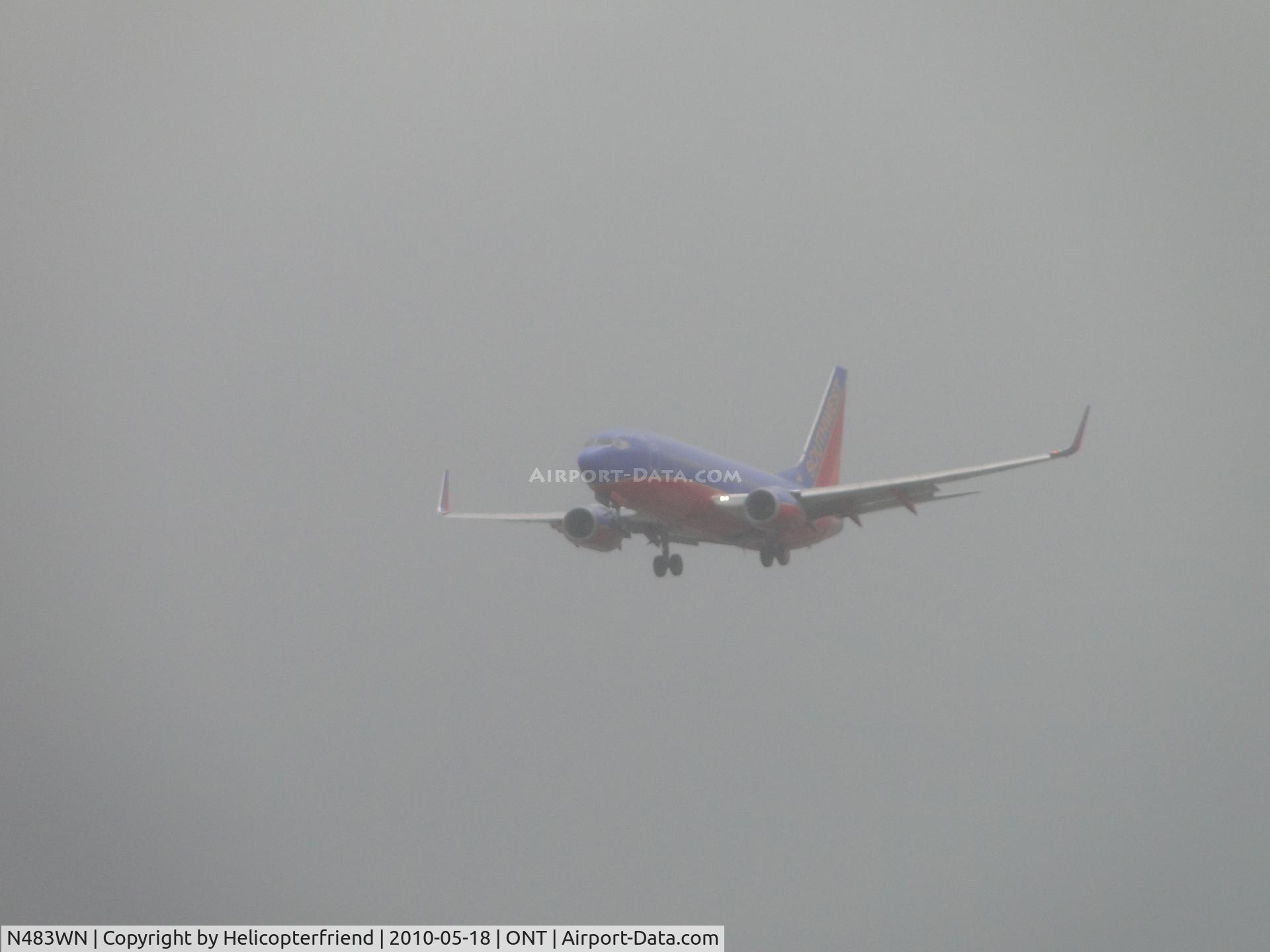 N483WN, 2004 Boeing 737-7H4 C/N 32472, On final out of the low clouds and drizzle
