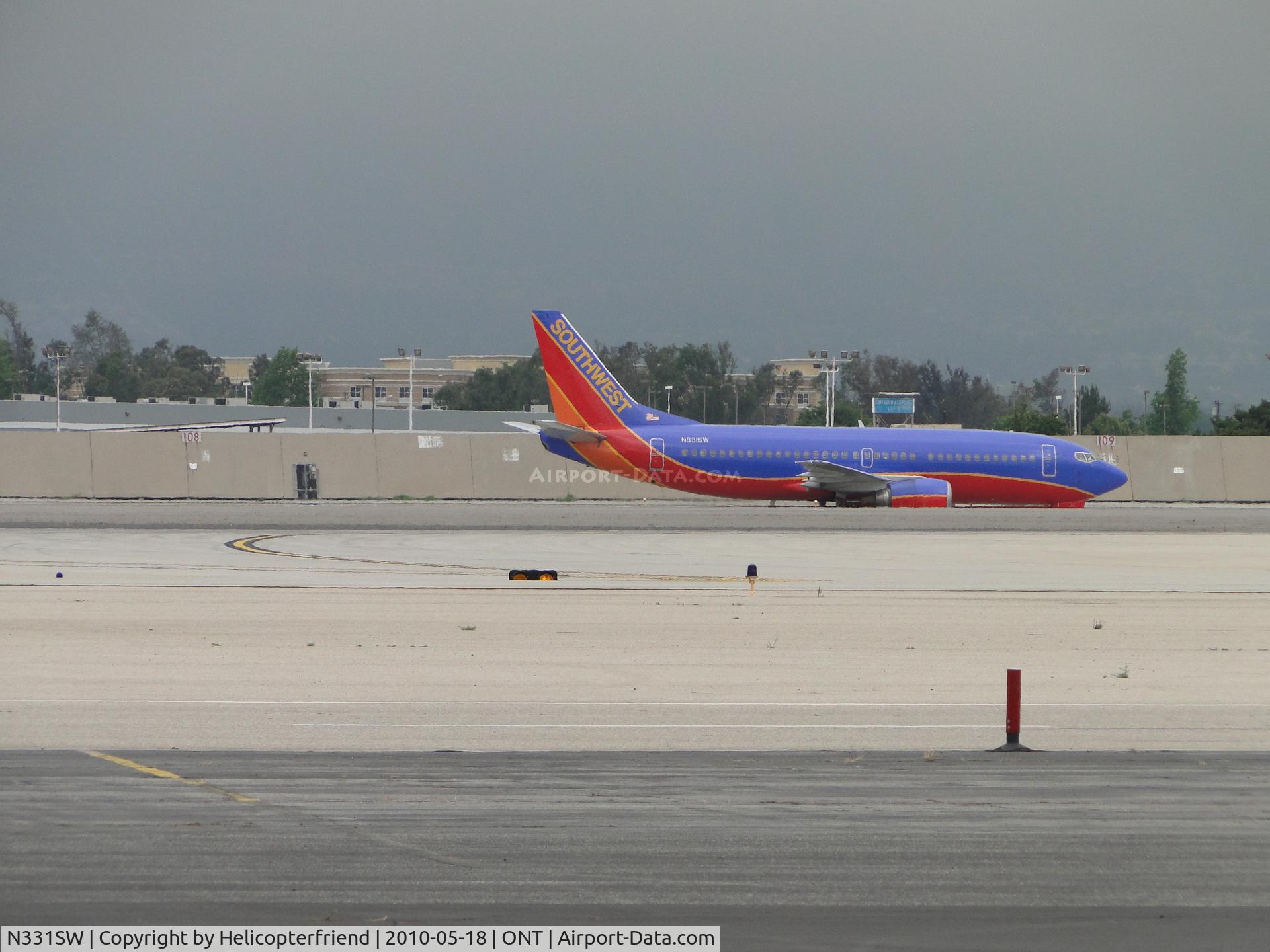 N331SW, 1988 Boeing 737-3H4 C/N 23695, Landed on 26L and taxied north to cross over 26R and enroute terminal