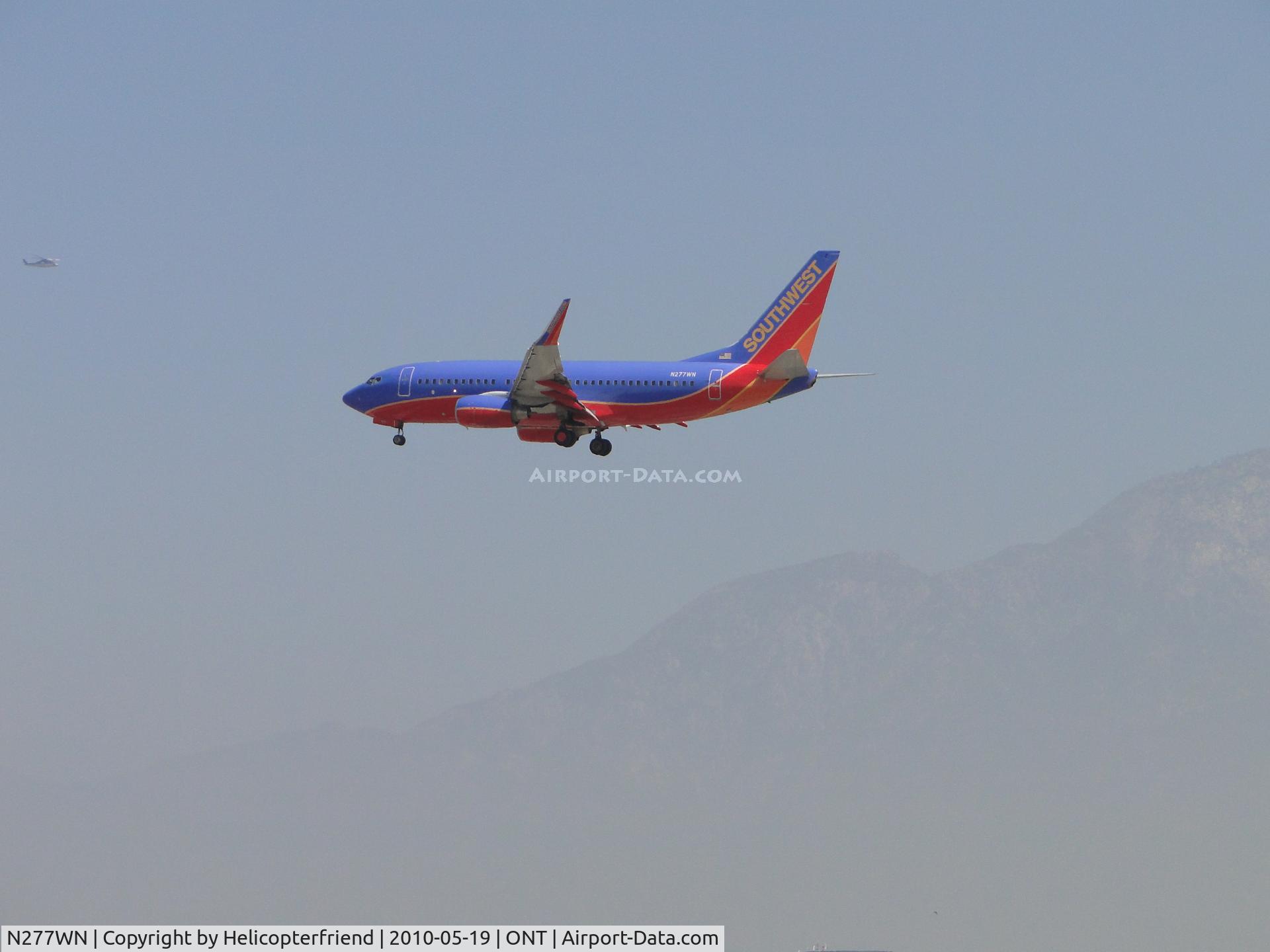 N277WN, 2007 Boeing 737-7H4 C/N 32531, On final to Ontario, notice eastbound helicopter north of and higher then this plane