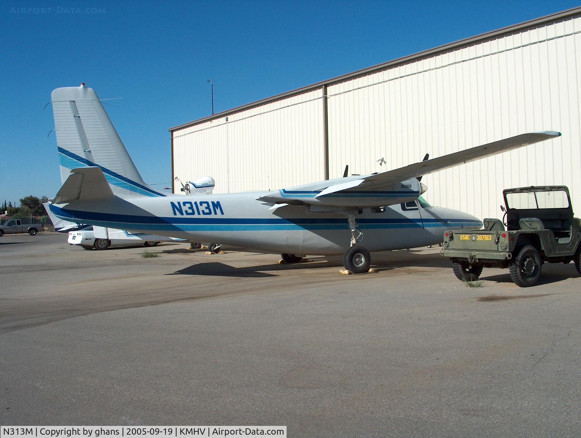 N313M, 1963 Aero Commander 500-A C/N 500A-1276-99, Parked between some hangars