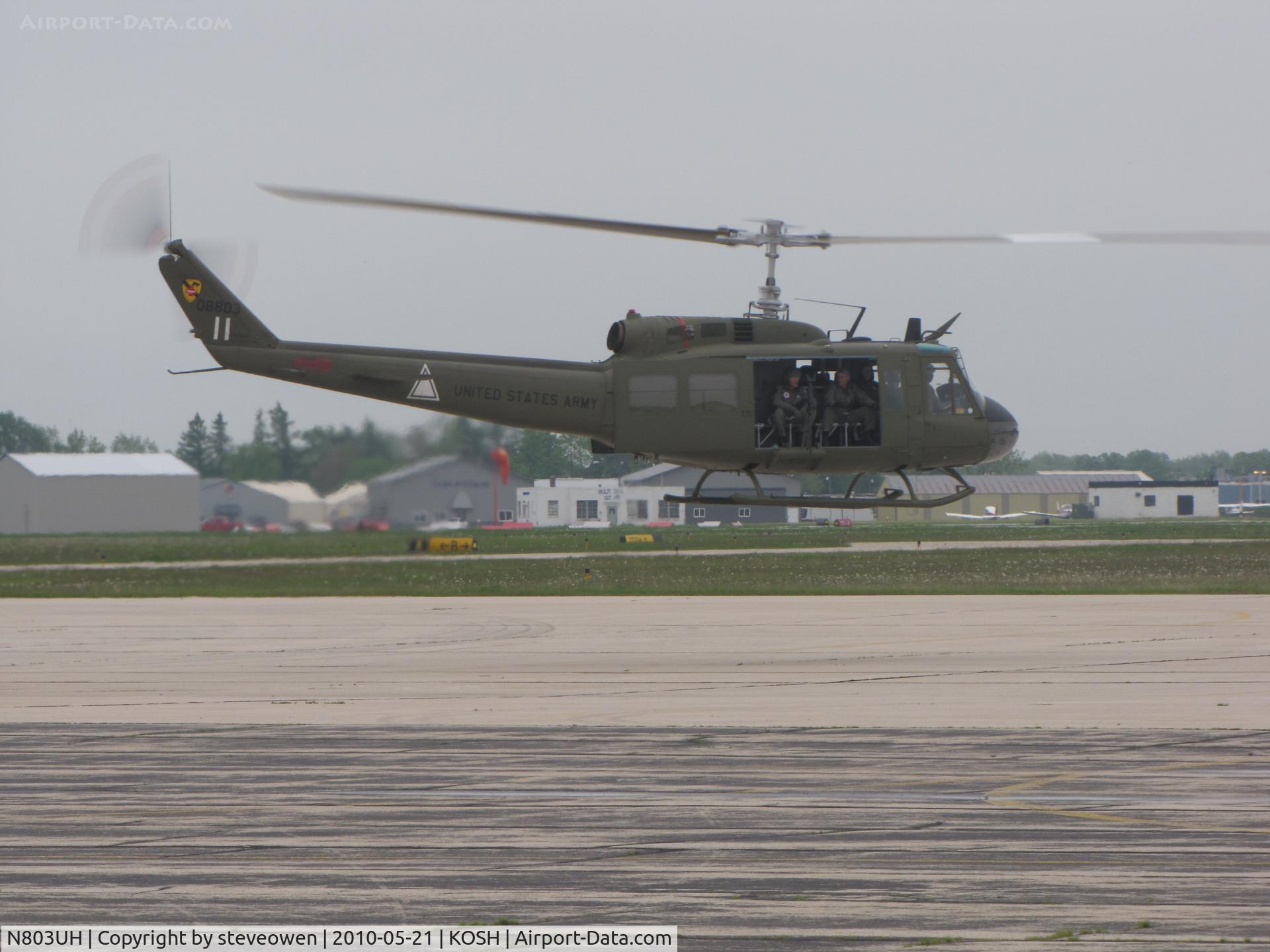N803UH, Bell UH-1H C/N 63-08803, lift off on an overcast day at oshkosh WI USA