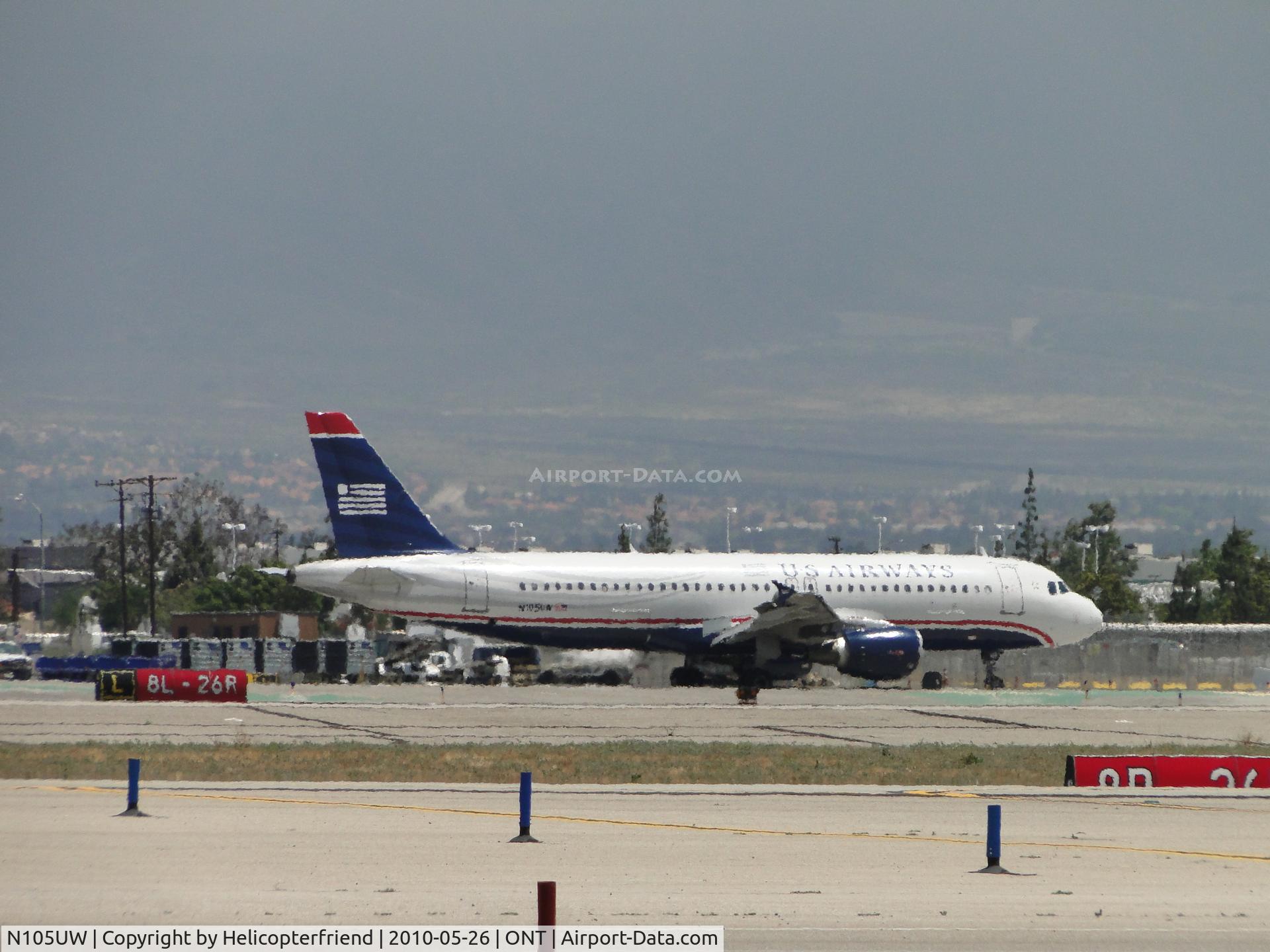 N105UW, 1999 Airbus A320-214 C/N 0868, Taxiing to terminal north of runway 26R