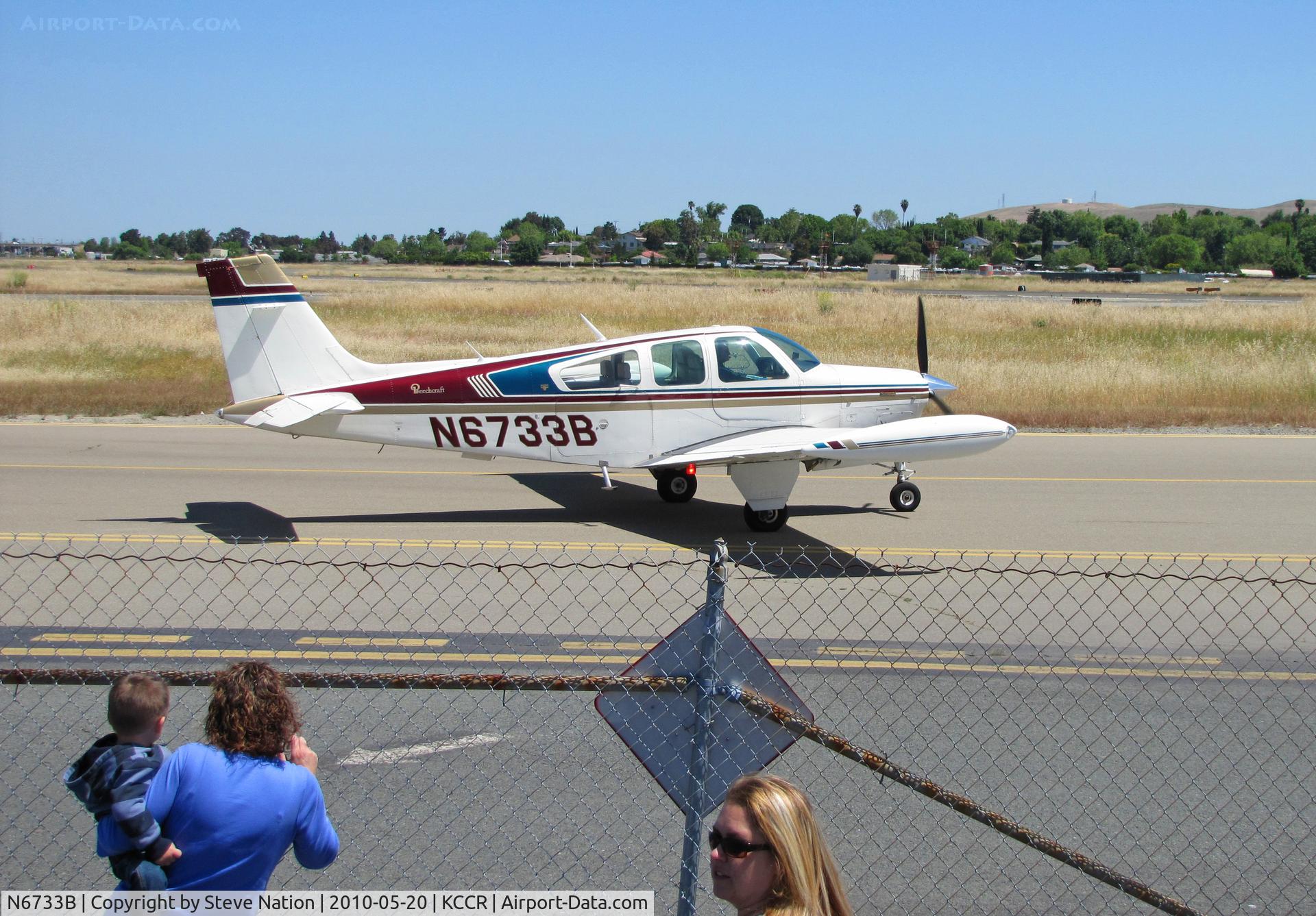 N6733B, 1980 Beech F33A Bonanza C/N CE-919, This is where the NEXT GENERATION of pilots get the urge (fenced viewing area at KCCR Concord, CA gives a safe close-up for kids)