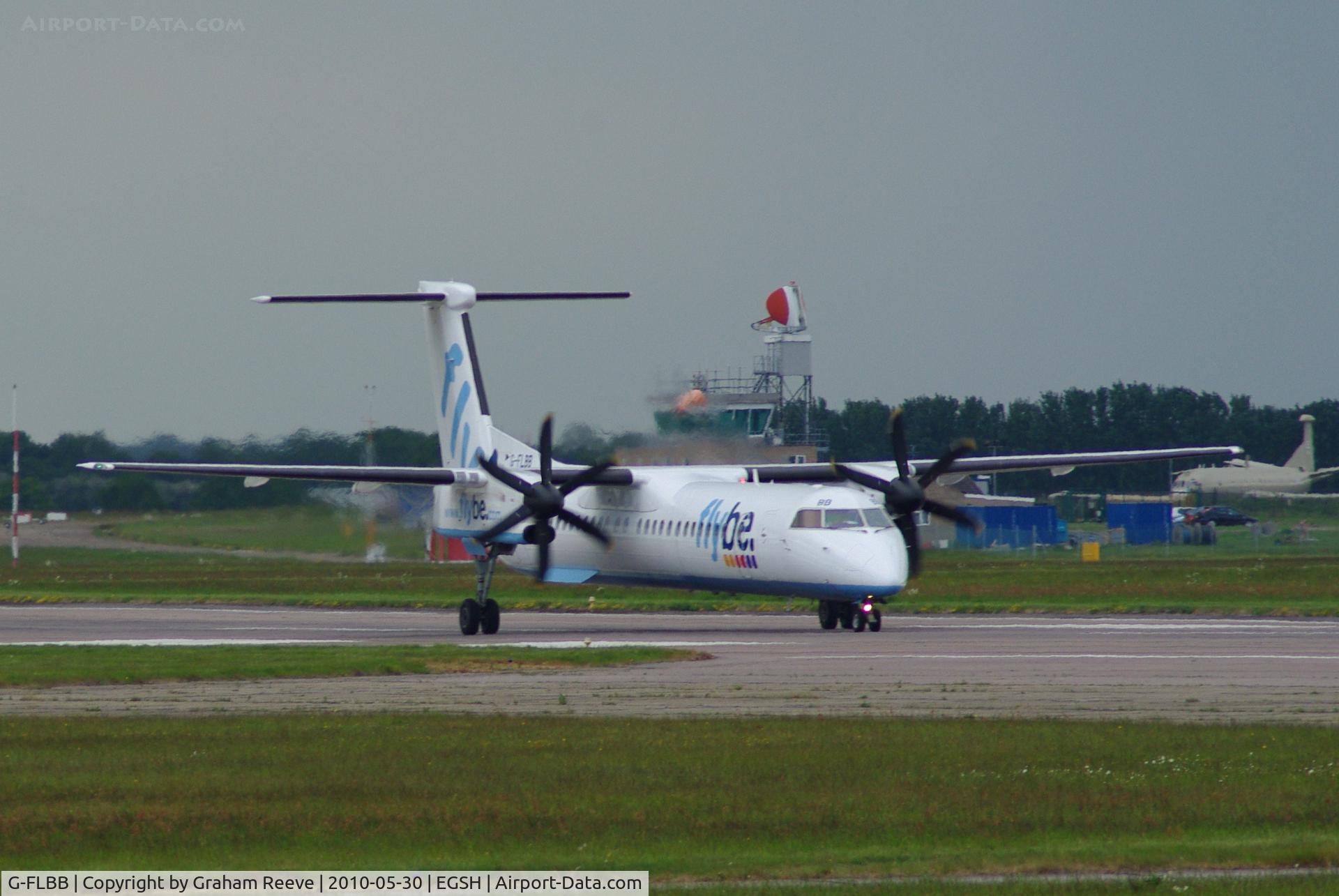 G-FLBB, 2009 De Havilland Canada DHC-8-402Q Dash 8 C/N 4255, About to take off from Norwich. Nimrod in the back ground is a new addition to the museum.