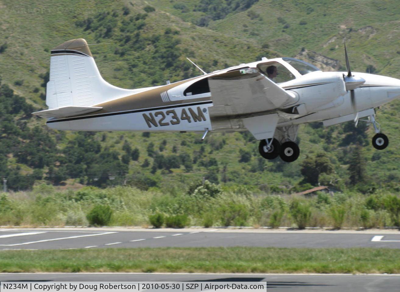 N234M, 1963 Beech D95A Travel Air C/N TD-560, 1963 Beech D95A TRAVEL AIR, two Lycoming IO-360-B1A 180 Hp each, takeoff climb Rwy 22