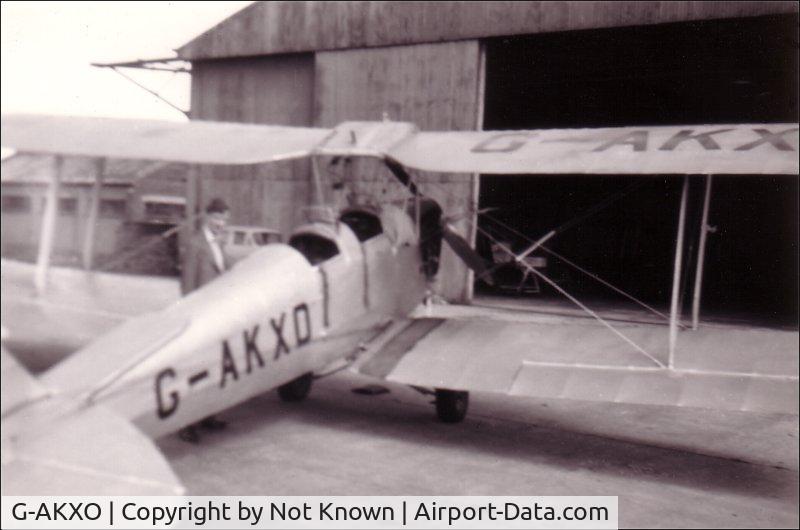 G-AKXO, 1940 De Havilland DH-82A Tiger Moth II C/N 83548, This is G-AKXO when it was in use as a trainer at Sherburn in Elmet in Yorkshire, in 1956.  My eldest brother (indistinct picture behind) qualified in this Tiger Moth before he died as a result of a rugby accident later that year.  Sorry about the poor qu