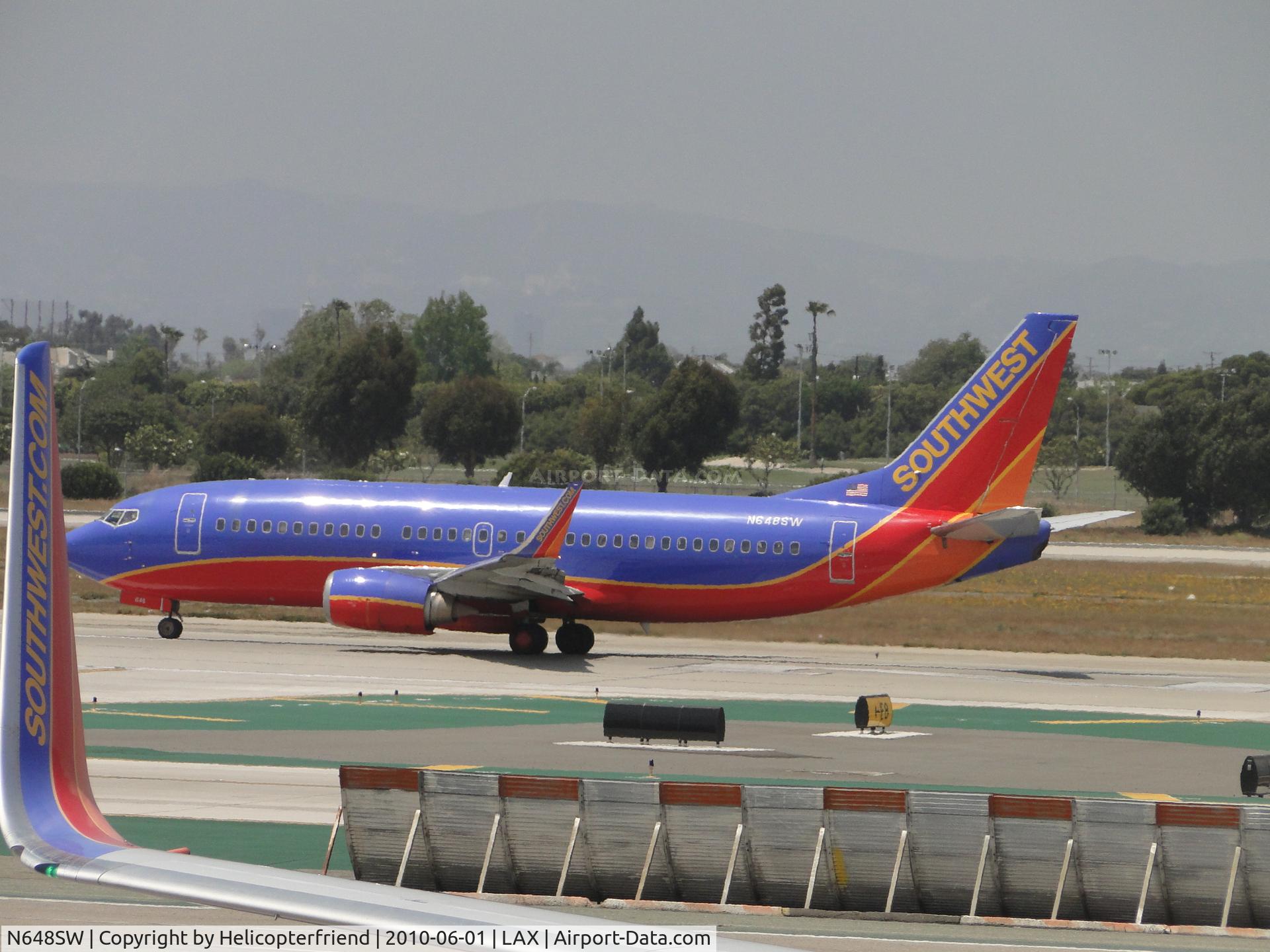 N648SW, 1997 Boeing 737-3H4 C/N 27718, Rolling west on runway 24L