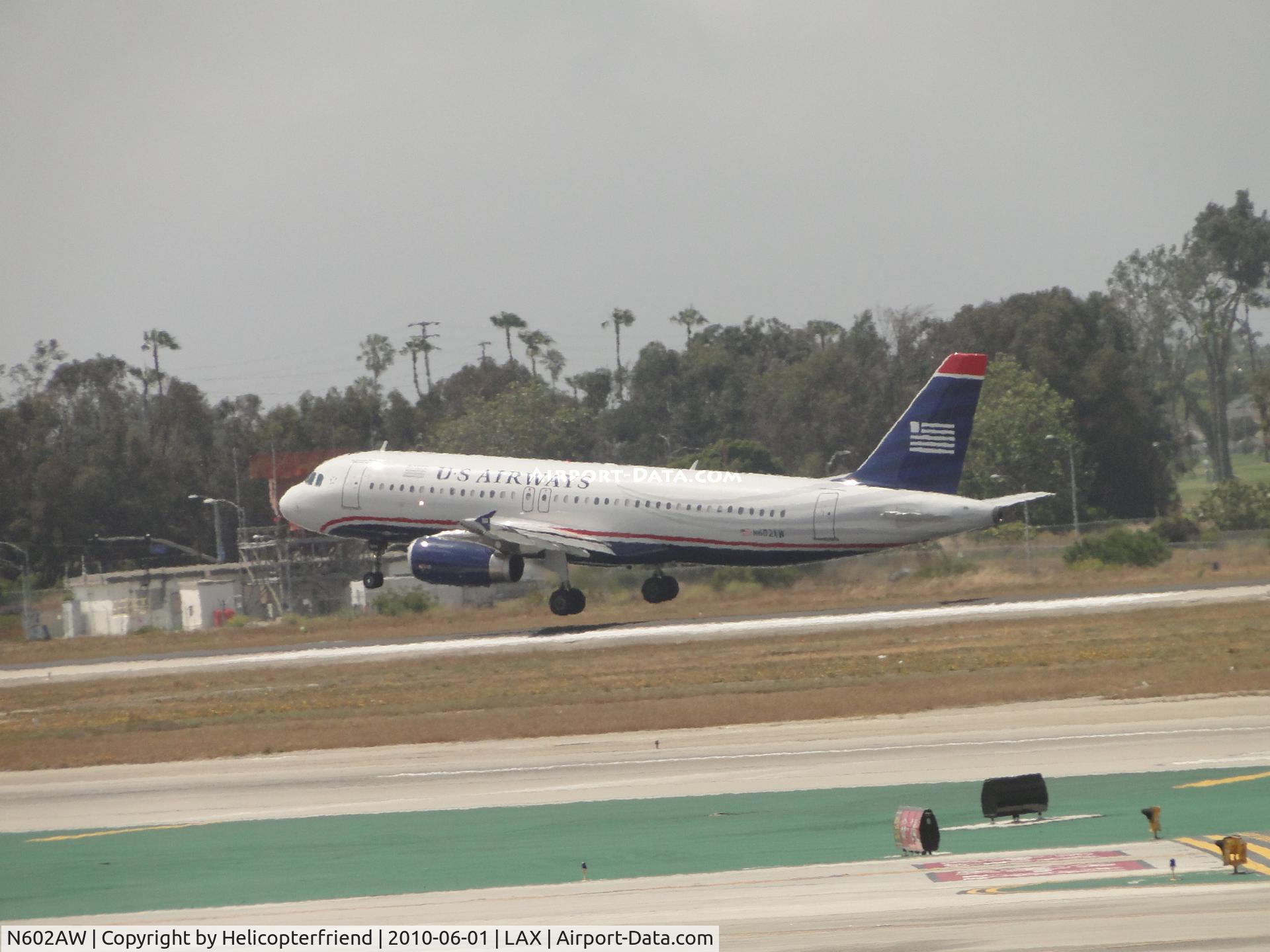 N602AW, 1995 Airbus A320-232 C/N 565, Almost touching down on runway 24R