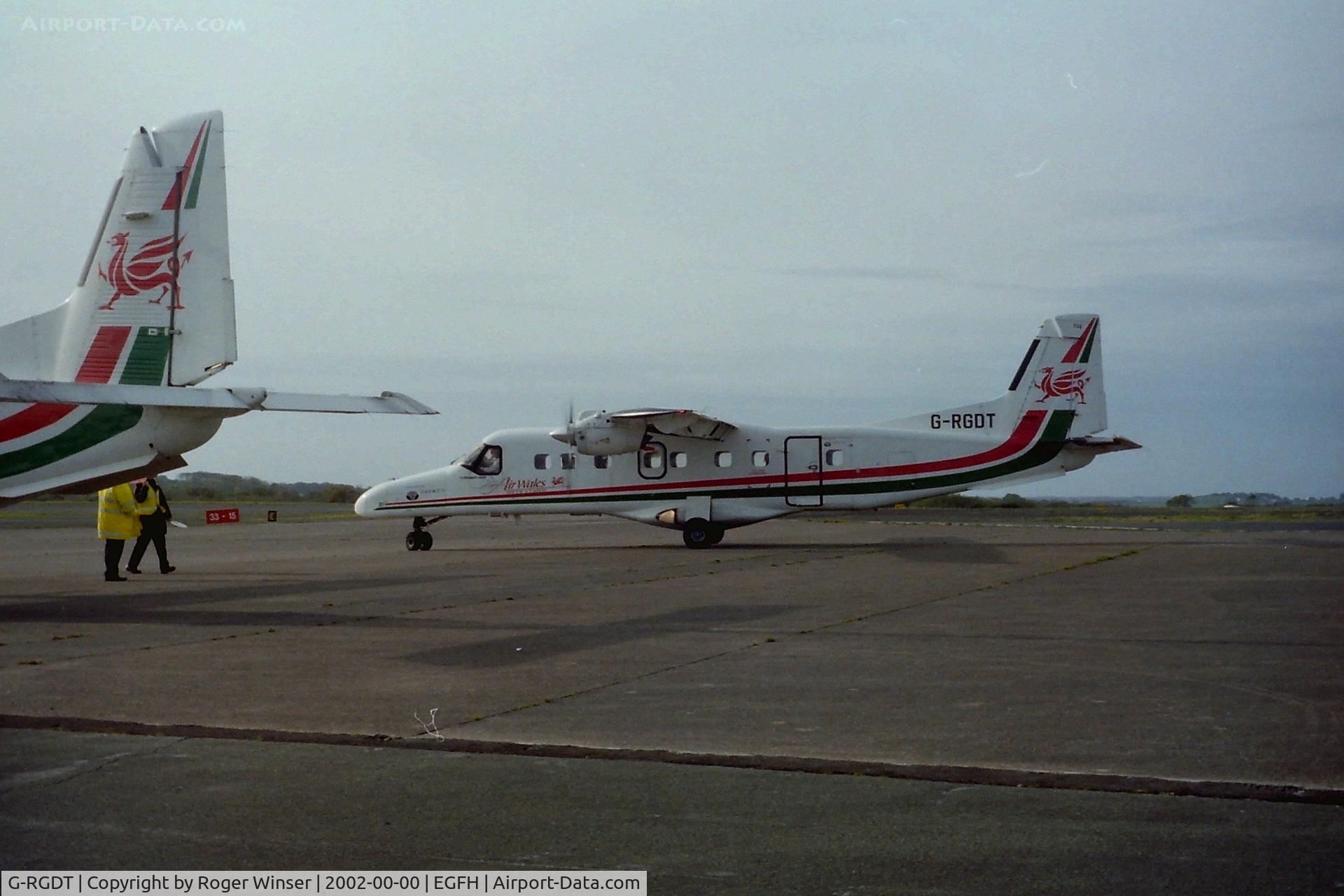 G-RGDT, 1986 Dornier 228-201K C/N 8070, Air Wales Dornier 228 based at Swansea Airport. Spring 2002. Tail of G-BUXT in the foreground.