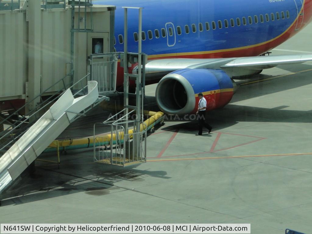N641SW, 1996 Boeing 737-3H4 C/N 27714, A member of the Flight Crew doing a walk around inspection of the aircraft