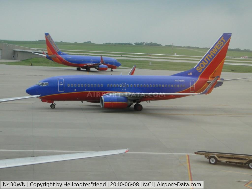 N430WN, 2002 Boeing 737-7H4 C/N 33659, Taxiing to termial passing an outbound SWA plane
