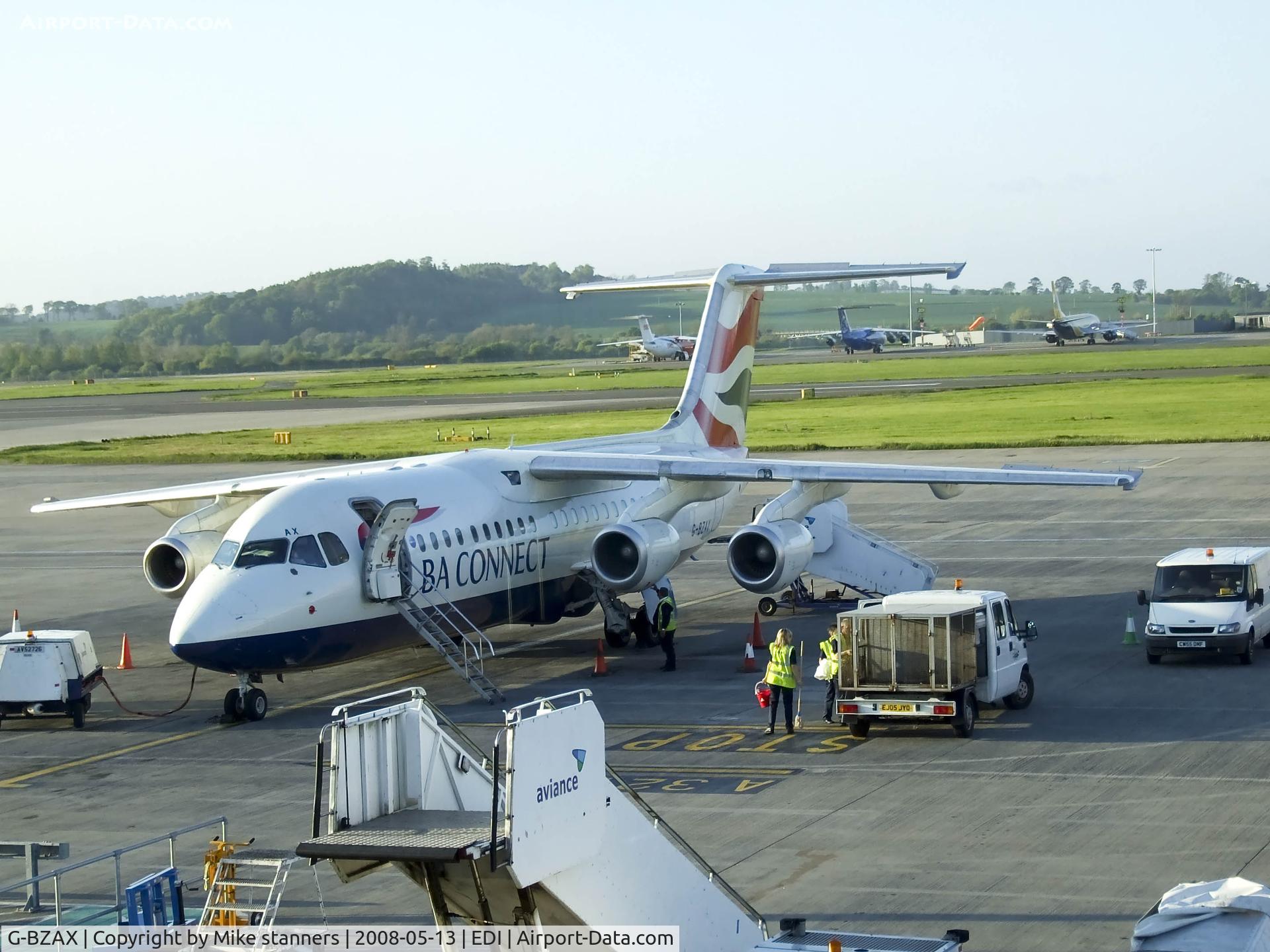 G-BZAX, 1999 British Aerospace Avro 146-RJ100 C/N E3356, G-BZAX On the apron surrounded by support equipment
