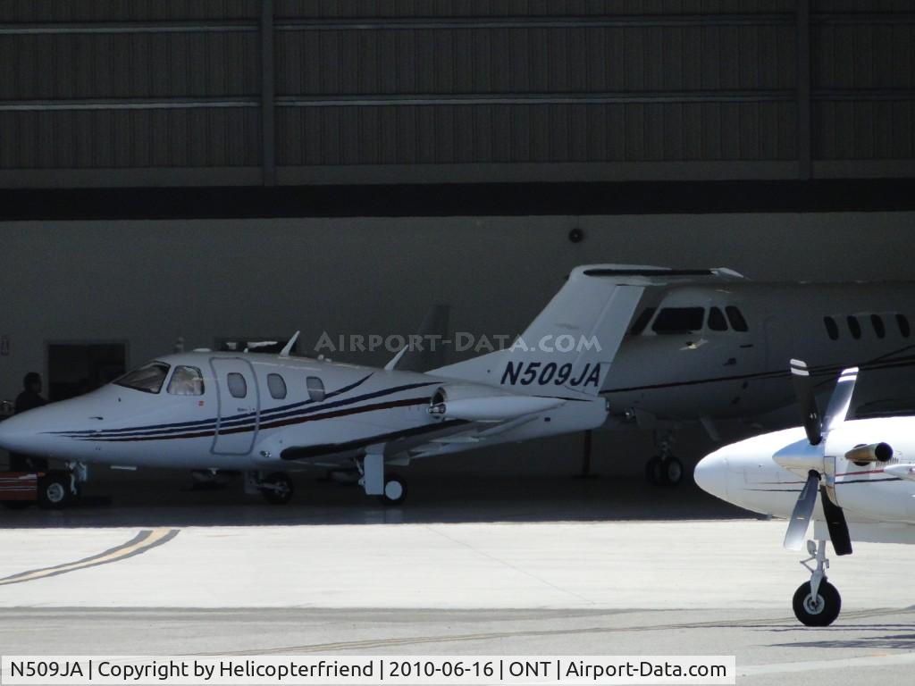 N509JA, 2007 Eclipse Aviation Corp EA500 C/N 000084, Being pushed back into a hanger out of the elements