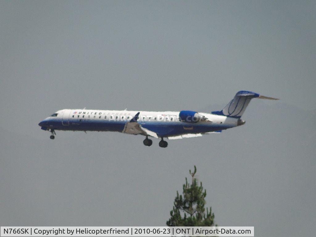 N766SK, 2005 Bombardier CRJ-702 (CL-600-2C10) Regional Jet C/N 10232, United Express operated by Sky West coming out of the haze on final to Ontario