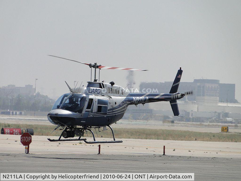 N211LA, 1987 Bell 206B JetRanger III C/N 3956, Appear to be working traffic at the stop sign on the southside of the airport