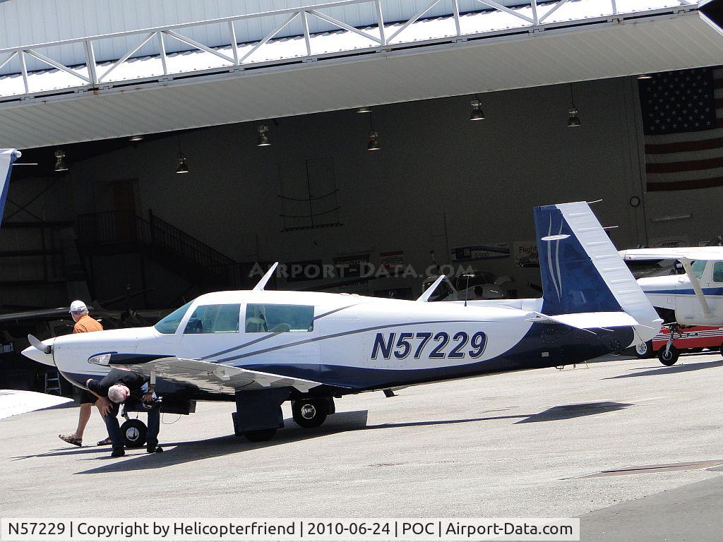 N57229, 1983 Mooney M20K C/N 25-0795, Pilot pre-flight checking aircraft parked at Howard Aviation