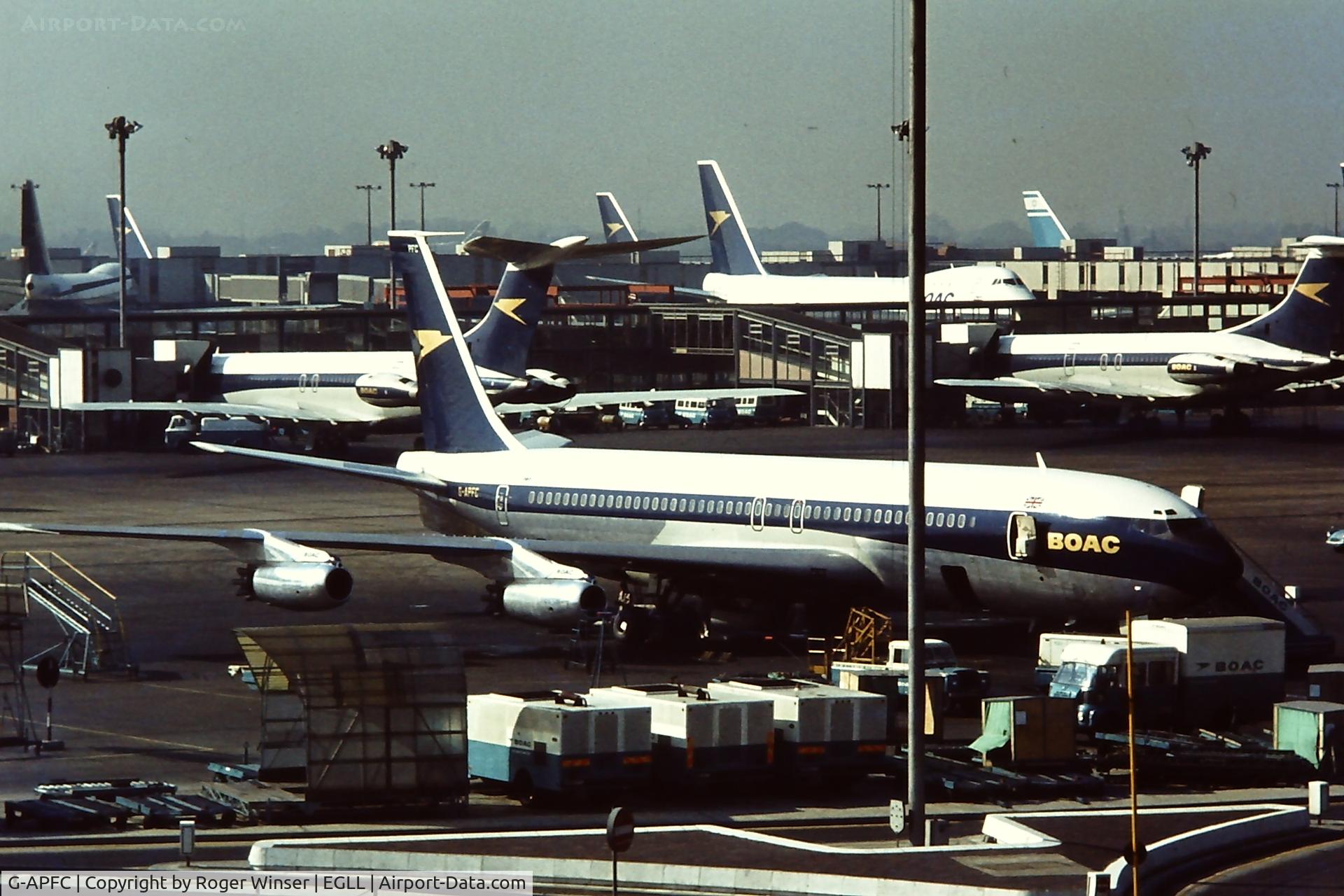 G-APFC, 1960 Boeing 707-436 C/N 17704, R.R Conway powered BOAC Boeing 707 seen from the Queen's Building at London Heathrow Airport in the early 1970's. Note the new BOAC Boeing 747 and Vickers VC10 aircraft in the background.