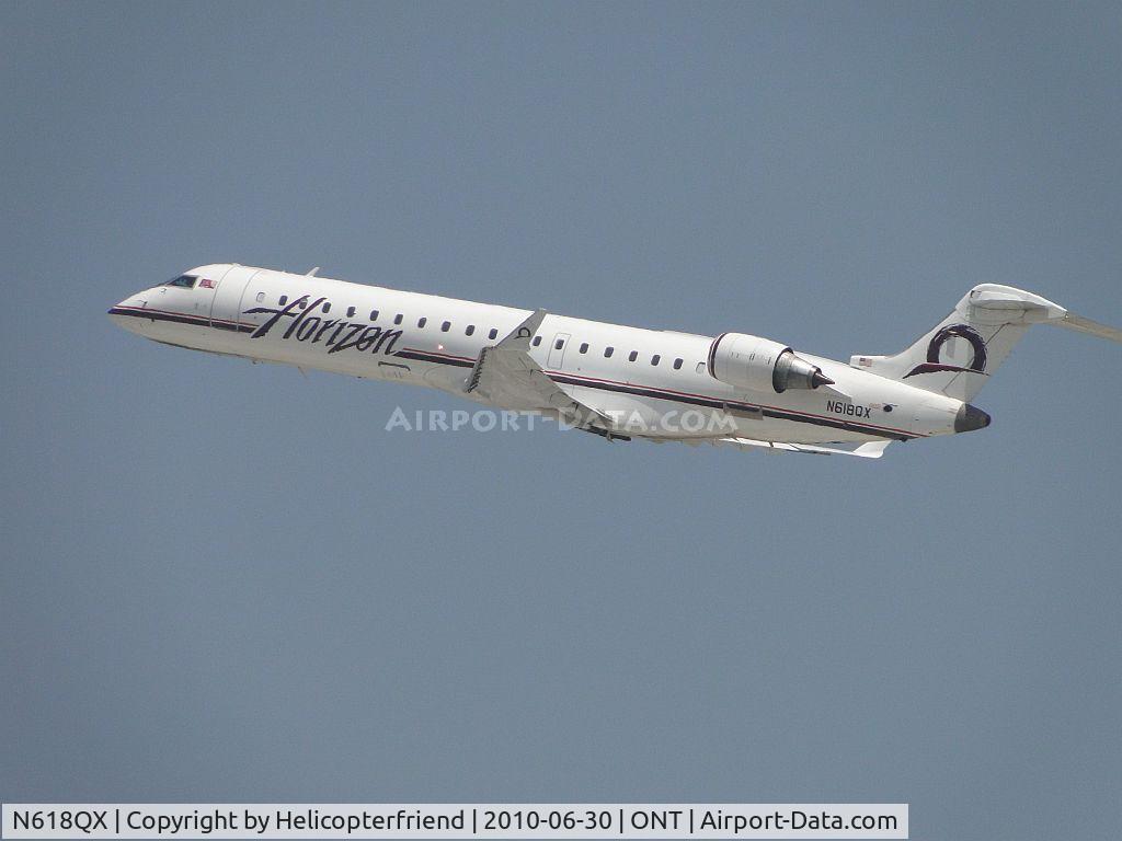 N618QX, 2005 Bombardier CRJ-701 (CL-600-2C10) Regional Jet C/N 10205, Wheels up and headed out westbound from runway 26R