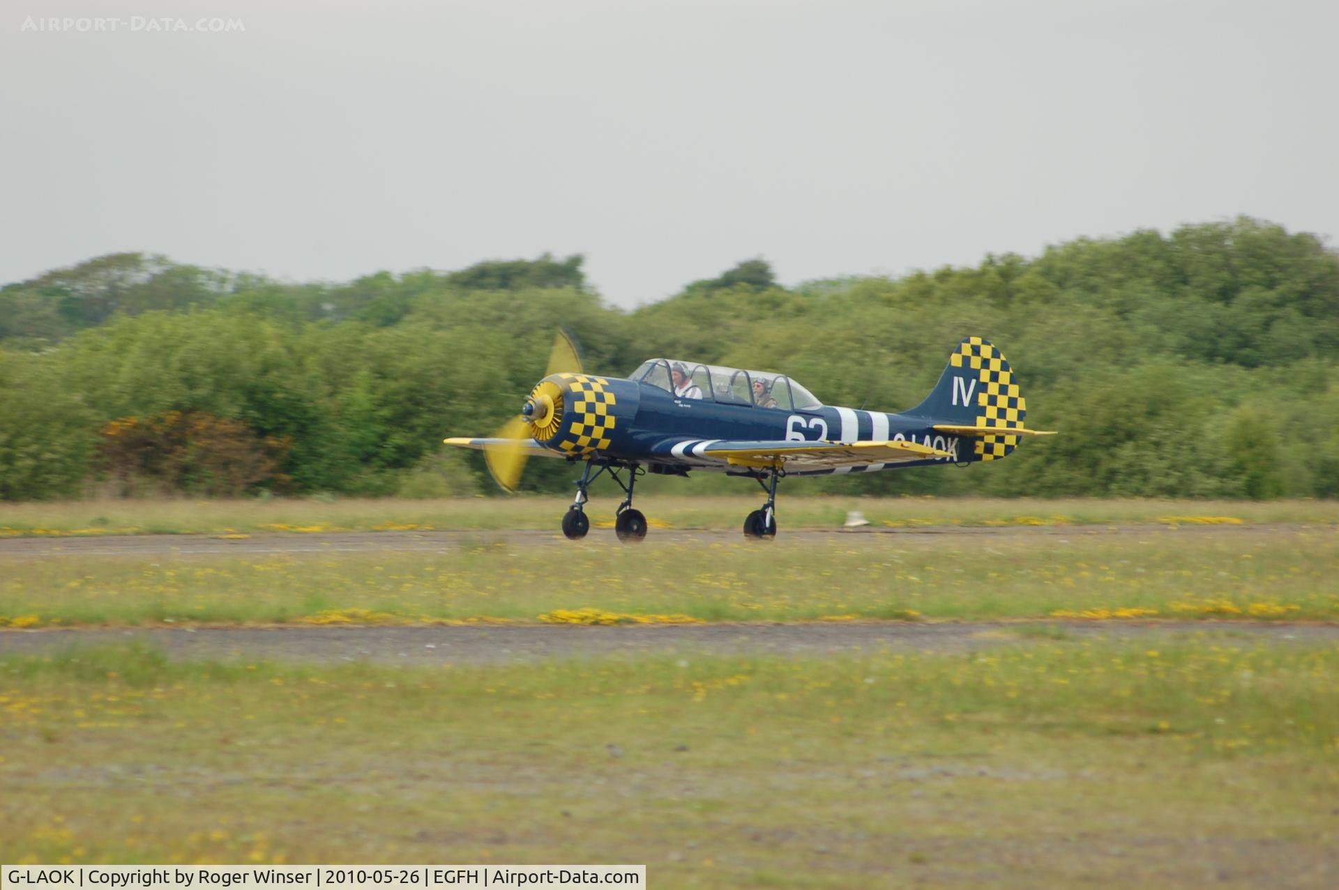 G-LAOK, 1987 Bacau Yak-52 C/N 877404, Colourful Yak departing Runway 22. De-registered on 23 June 2010 to become G-OUGH.