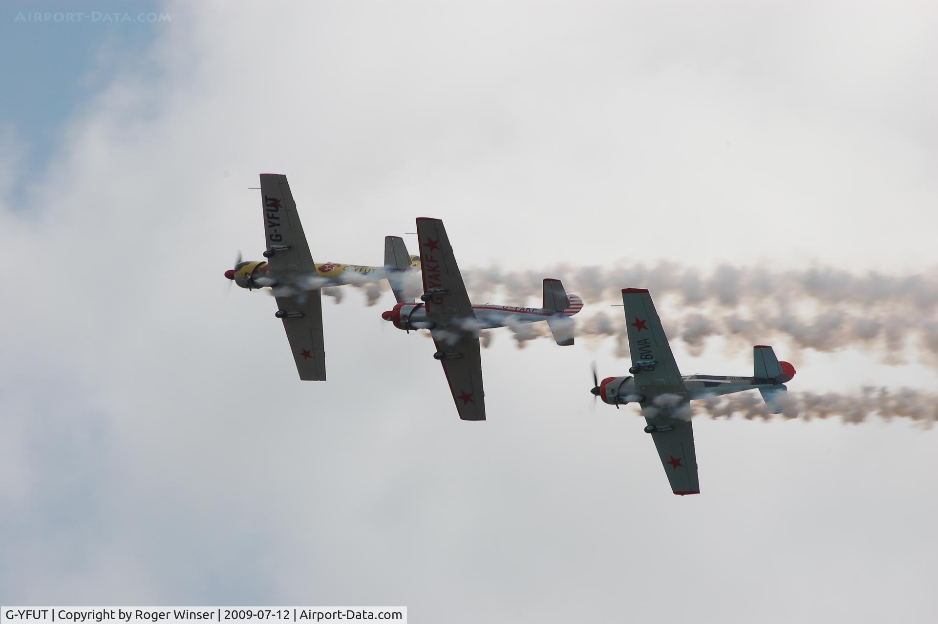 G-YFUT, 1988 Bacau Yak-52 C/N 888410, Off airport. Team Osprey led by G-YFUT with G-YAKF and G-BVVA at the 2011 Wales National Airshow, Swansea Bay, Wales, UK.