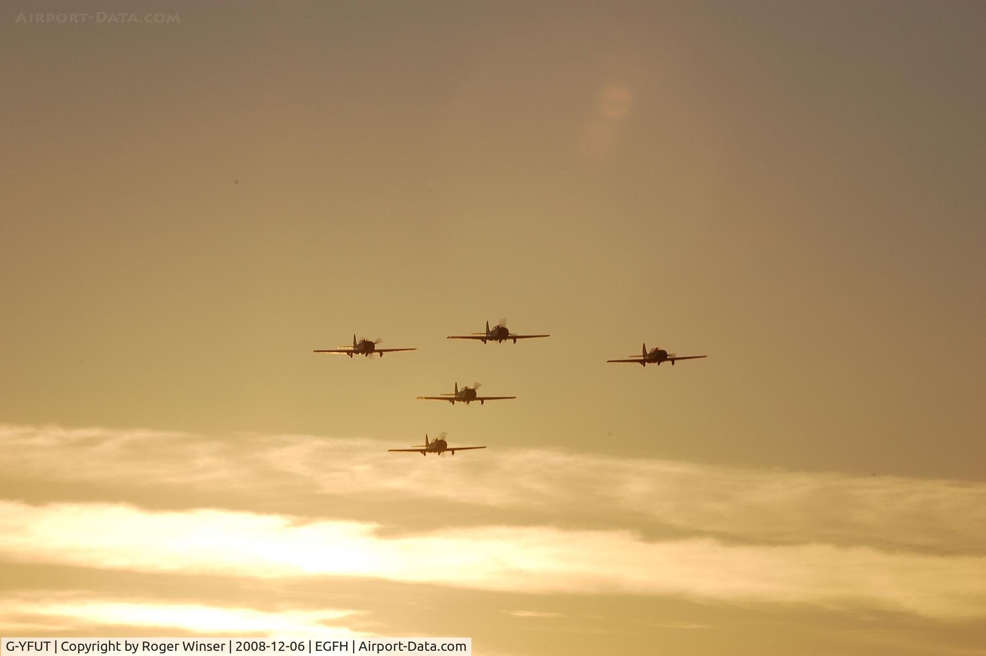 G-YFUT, 1988 Bacau Yak-52 C/N 888410, Five ship formation of Yak-52 aircraft including G-YFUT returning to Swansea Airport after formation aerobatics practice.